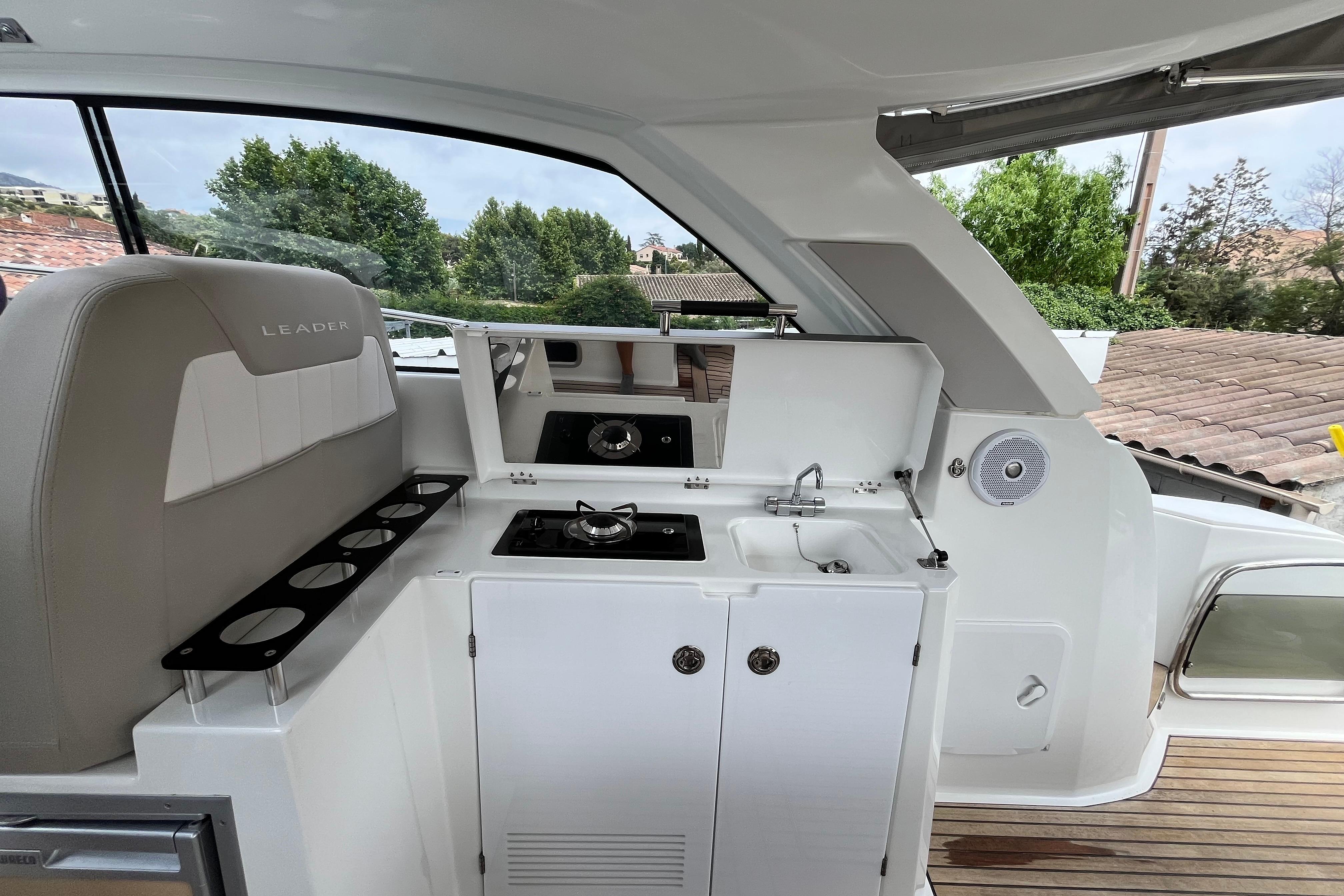 2017 Jeanneau Leader 40 yacht interior with kitchenette and seating area.