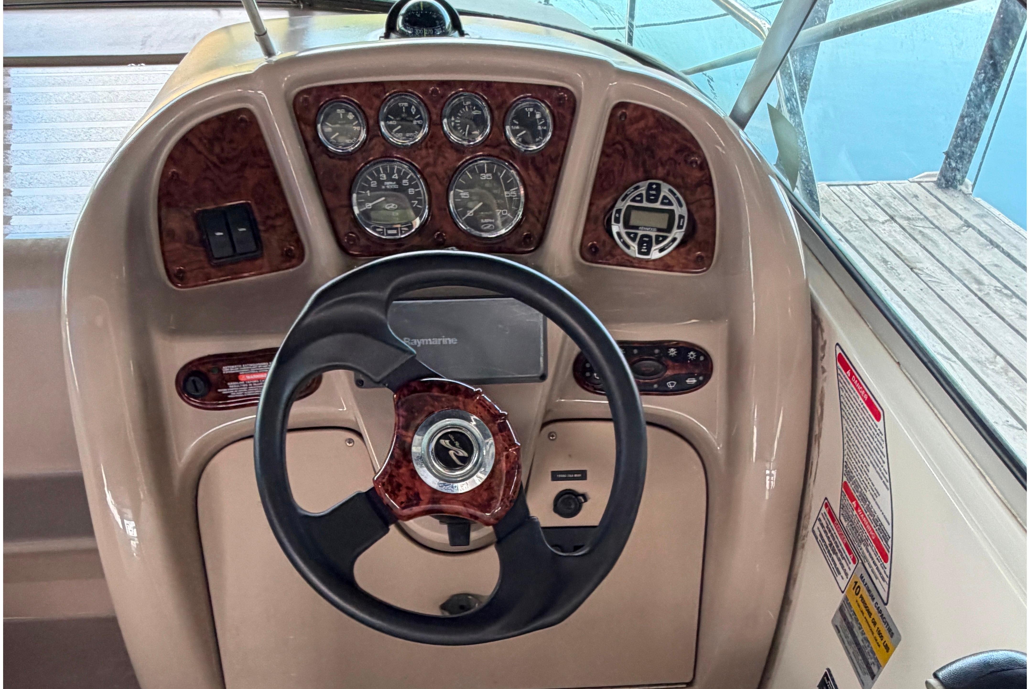 2004 Sea Ray Sundancer 260 helm with steering wheel and instrument panel.
