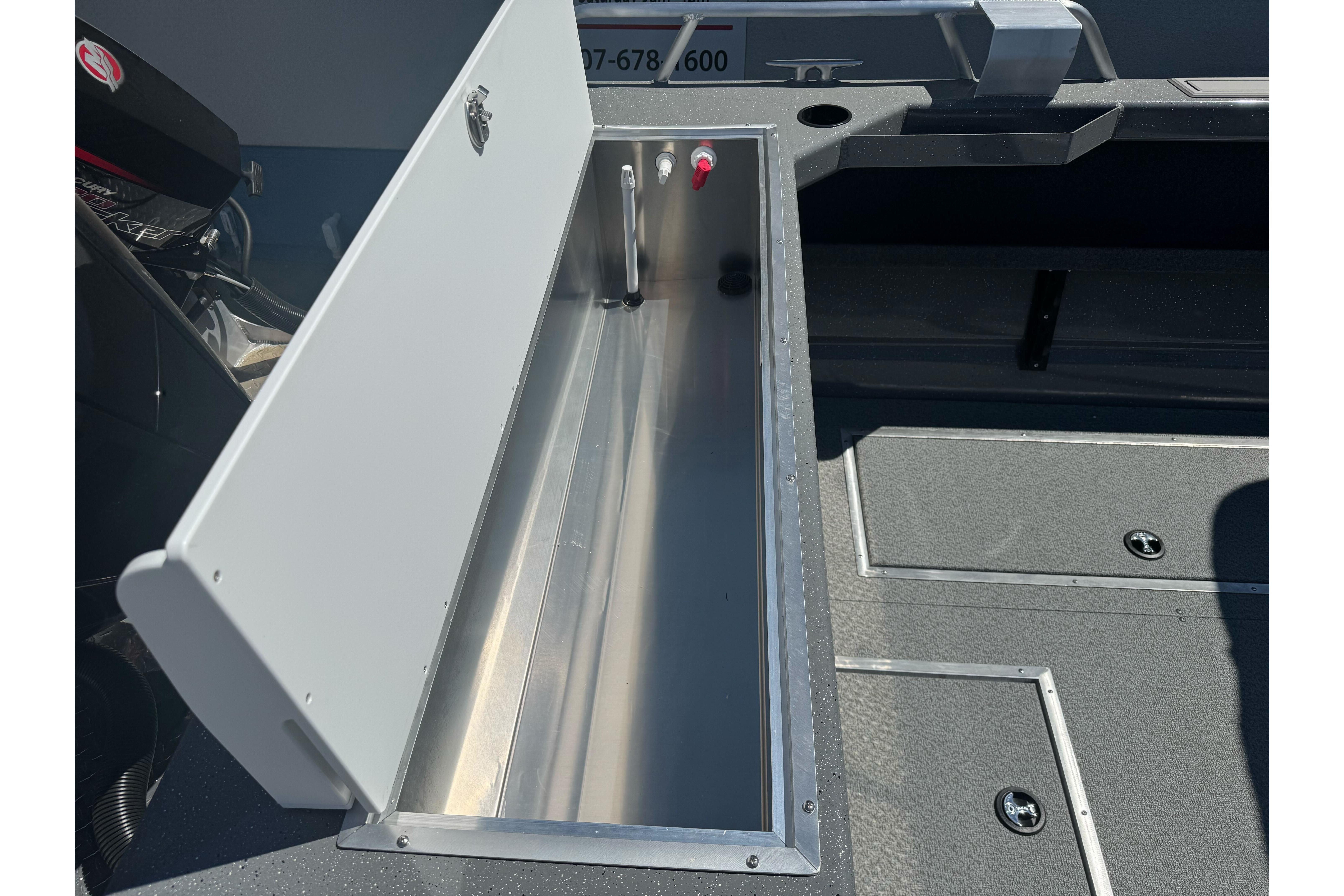 Open storage compartment in 2026 Lund 210 Heavy Gauge boat interior.