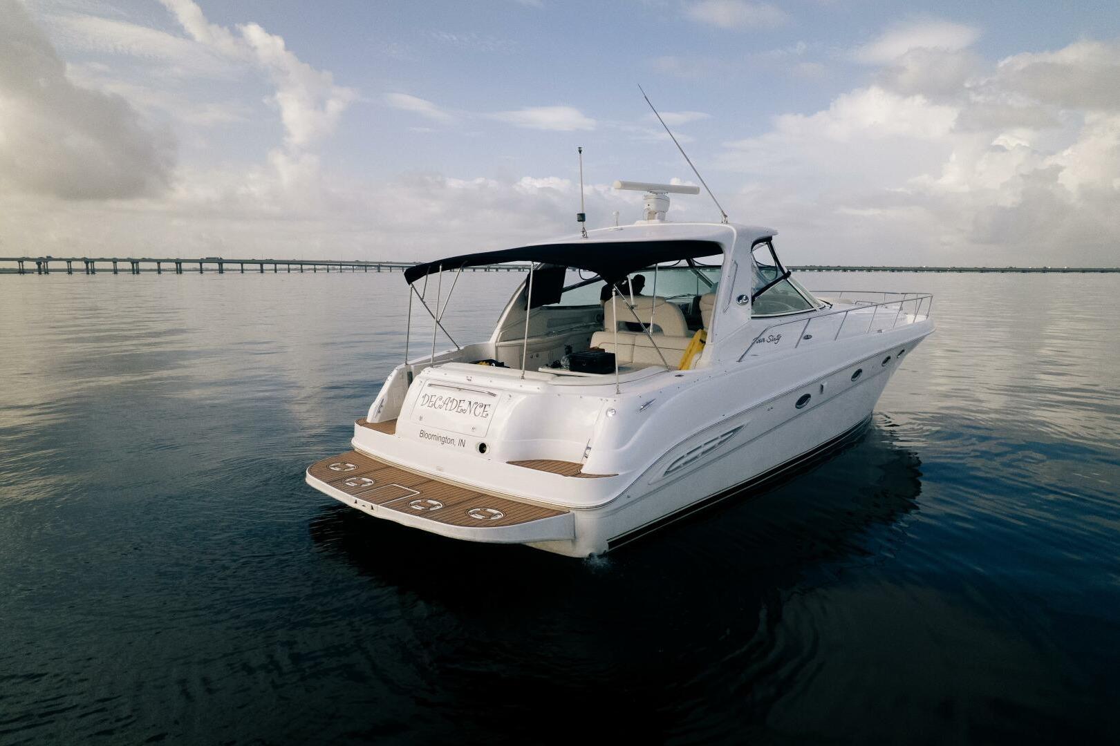 2003 Sea Ray Sundancer 460 yacht on calm water, featuring sleek design and spacious deck.