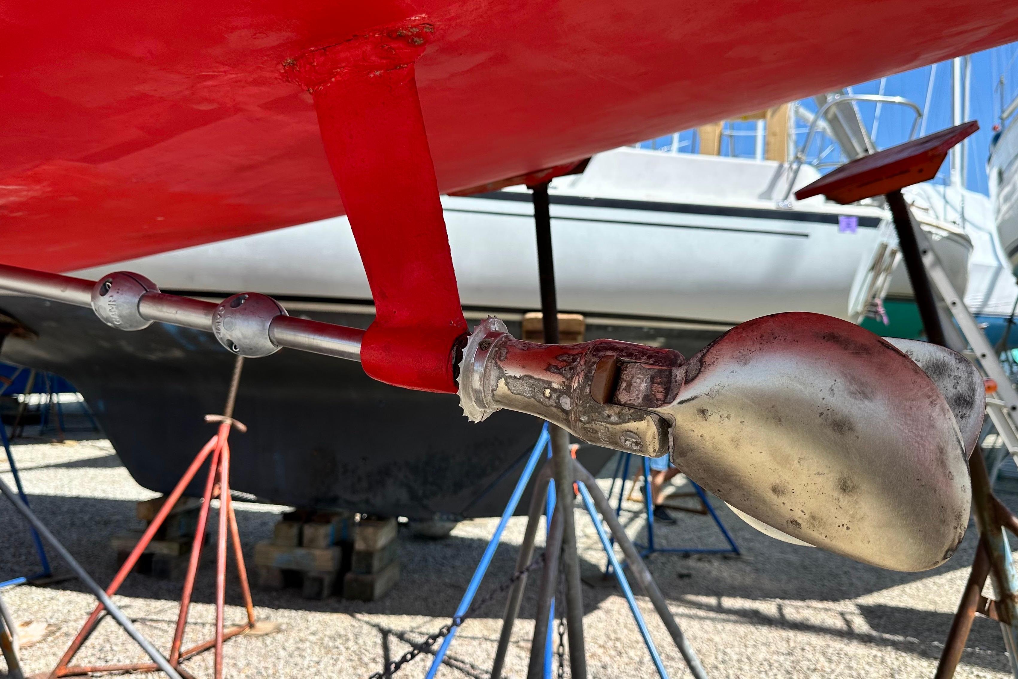 Propeller and rudder of 2016 Jeanneau Sun Odyssey 349 sailboat on stands.