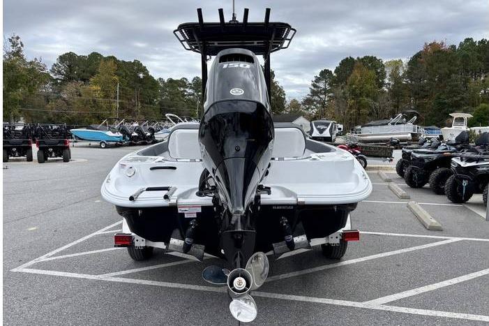 2026 ALK2 23CRX boat with powerful outboard motor in a parking lot.