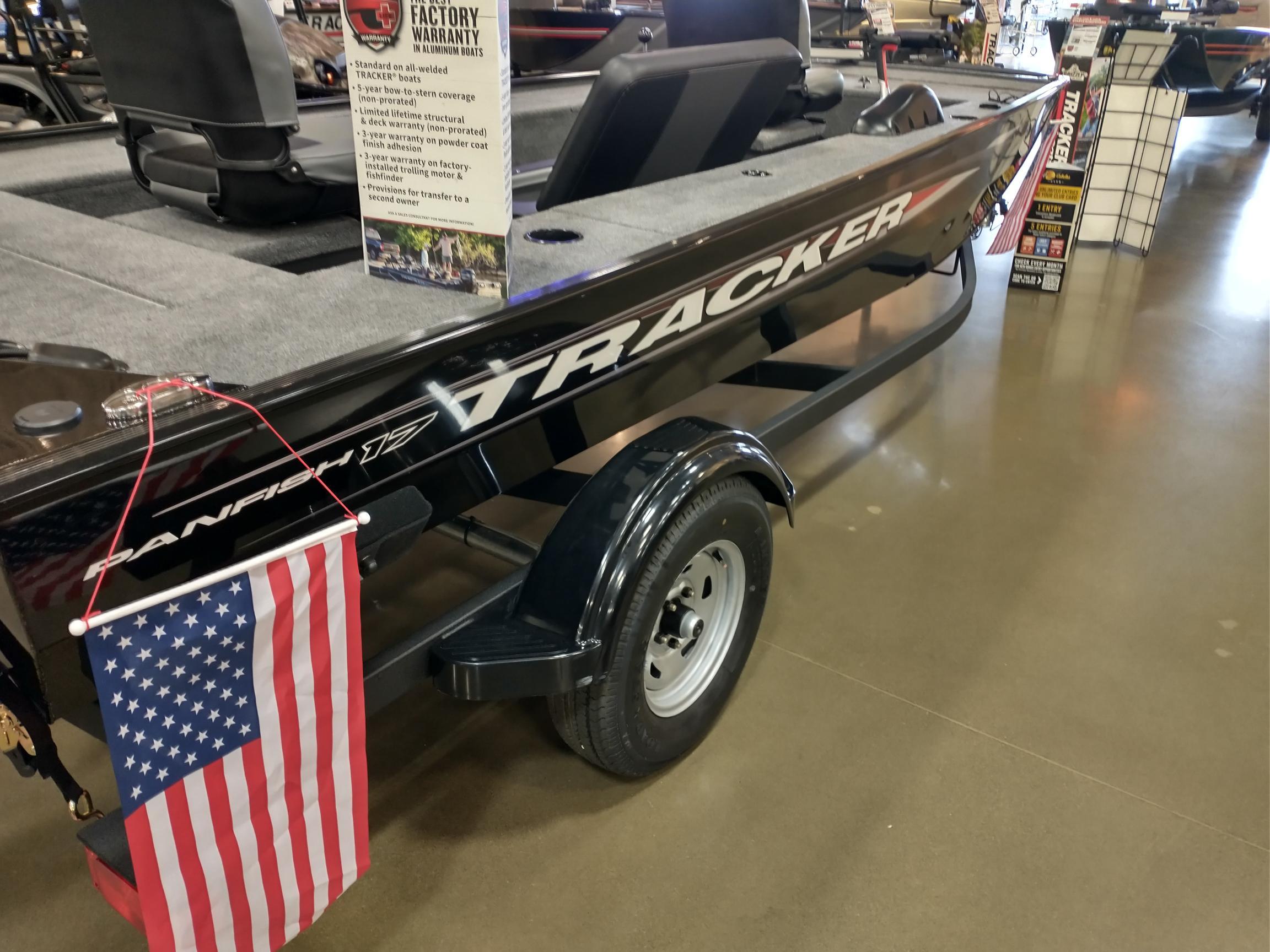 2025 Tracker Panfish 17 boat on display with American flag and warranty sign.