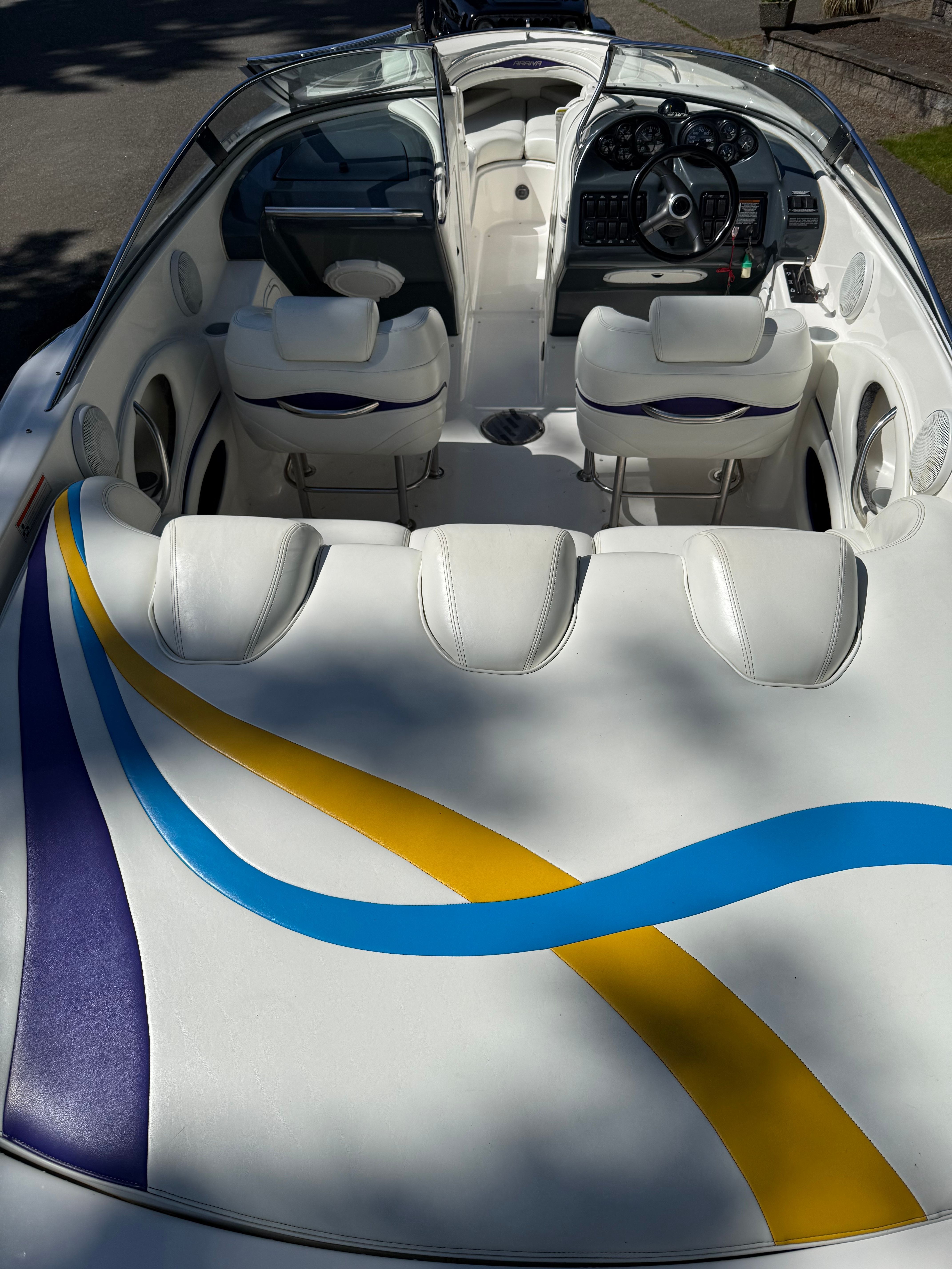 The image shows the cockpit of a 1997 Arriva 2550 boat with colorful stripes.