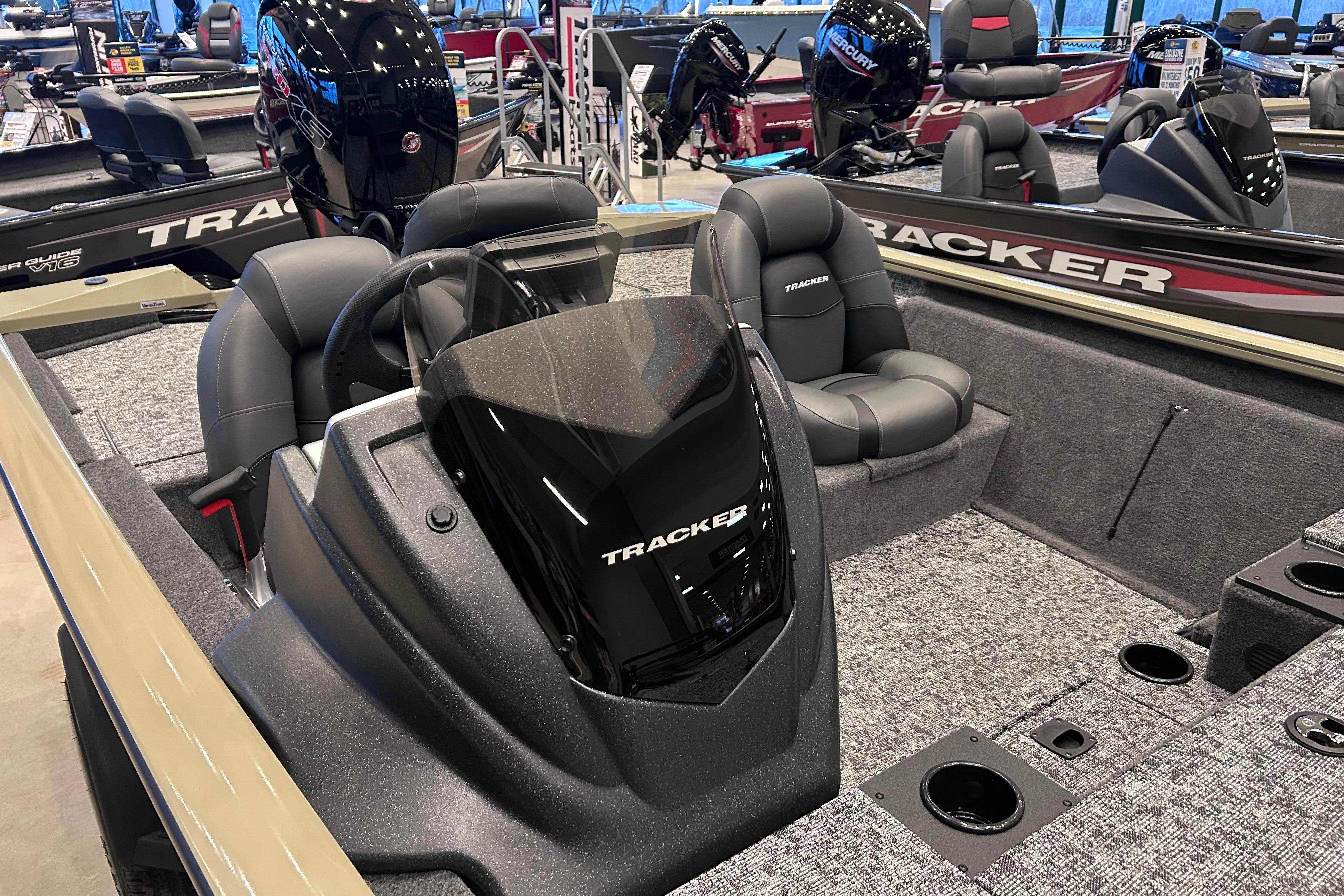 2026 Tracker Pro Team 195 boat interior with seating and console, displayed in showroom.