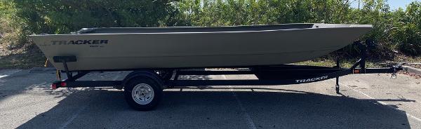 2025 Tracker GRIZZLY 2072 Utility boat on trailer, parked outdoors.