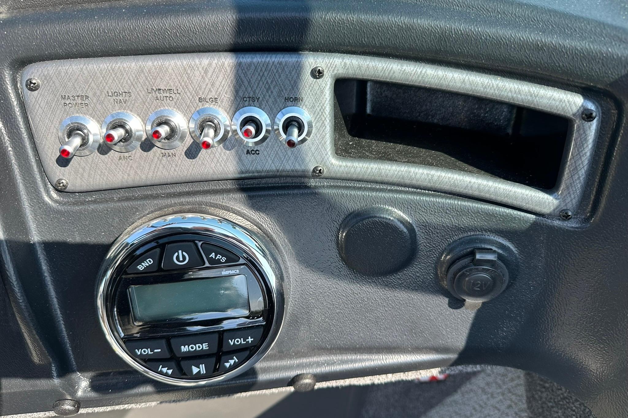 Control panel of 2026 Lund 1875 Fisherman boat with switches and audio system.