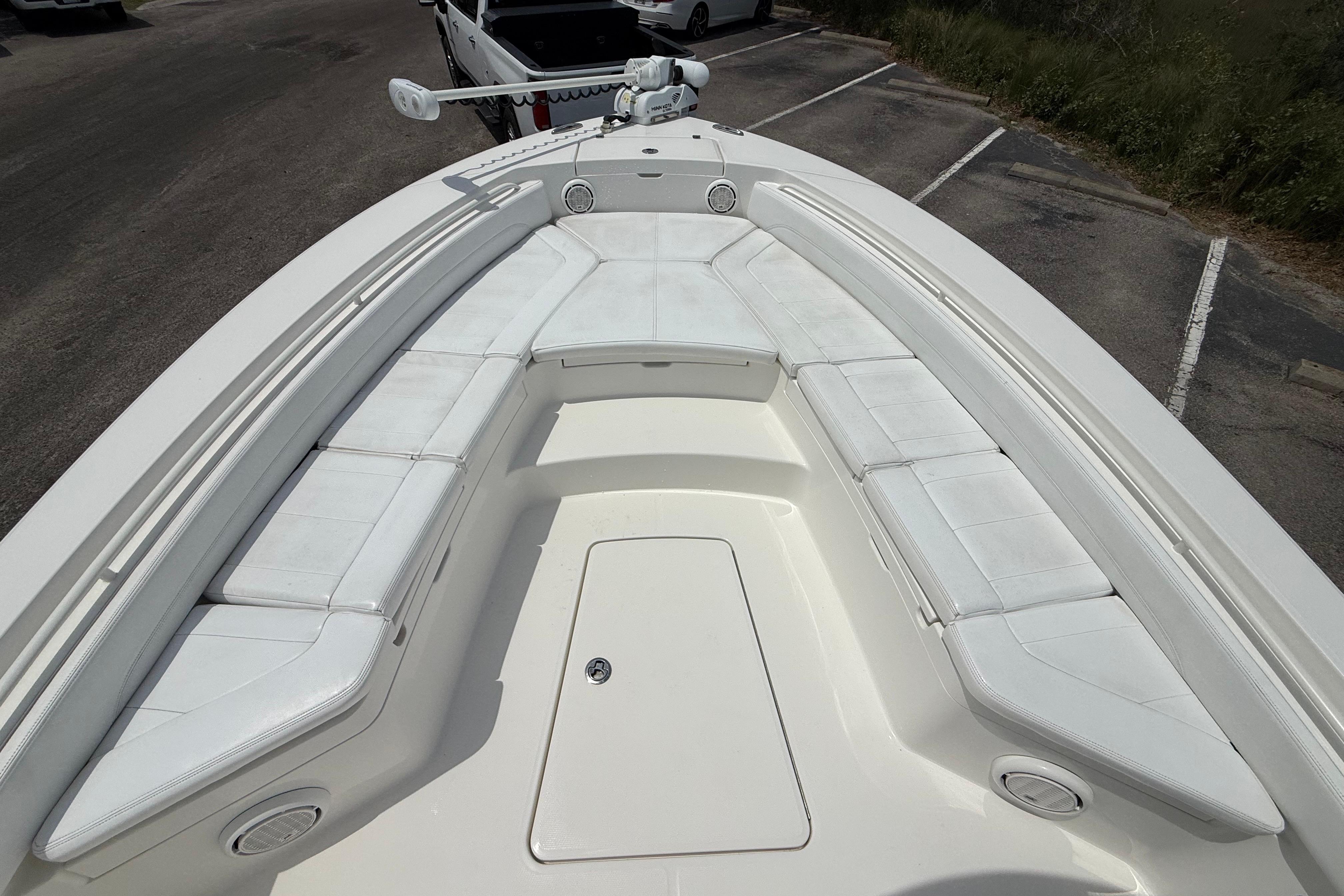 2019 Regulator 26XO boat with spacious white seating and storage compartments.