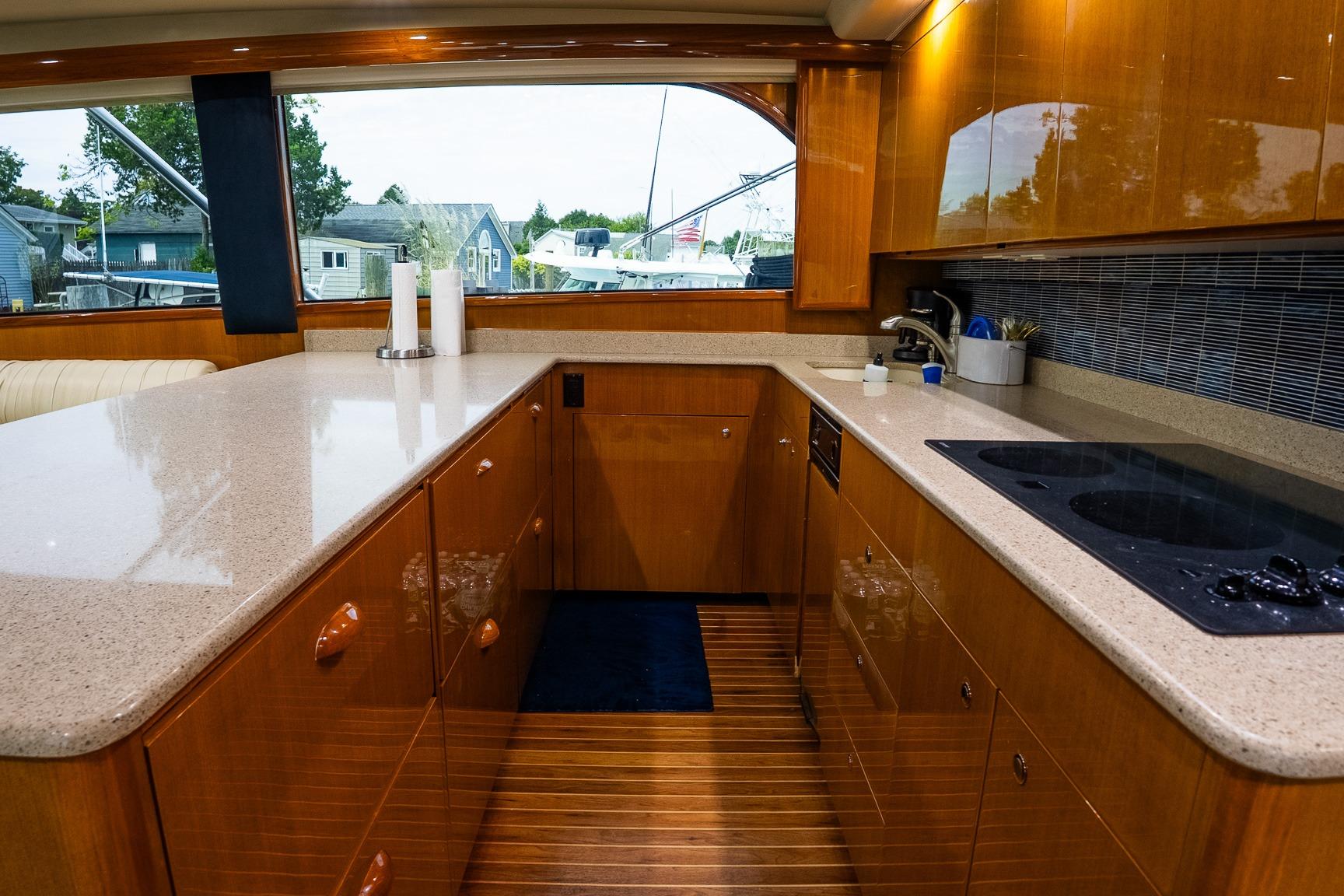 Luxurious kitchen interior of 2002 Viking 61 Enclosed Bridge yacht with modern amenities.
