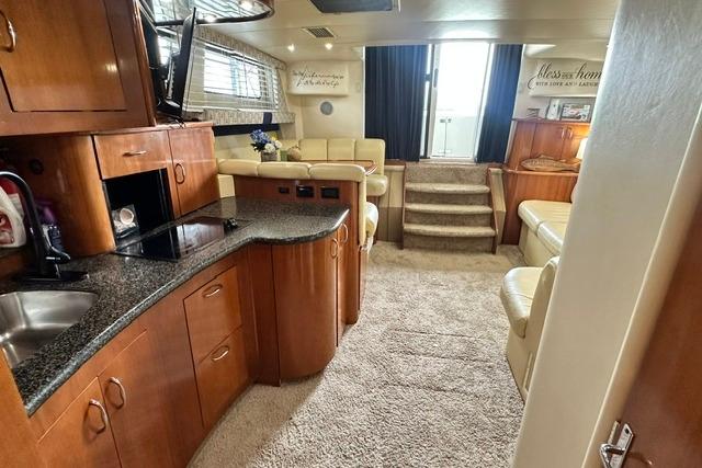 Interior of 2004 Carver 360 Mariner yacht with modern kitchen and cozy seating area.