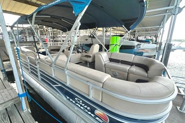2019 Sun Tracker Party Barge 22 XP3 pontoon boat docked under a canopy.
