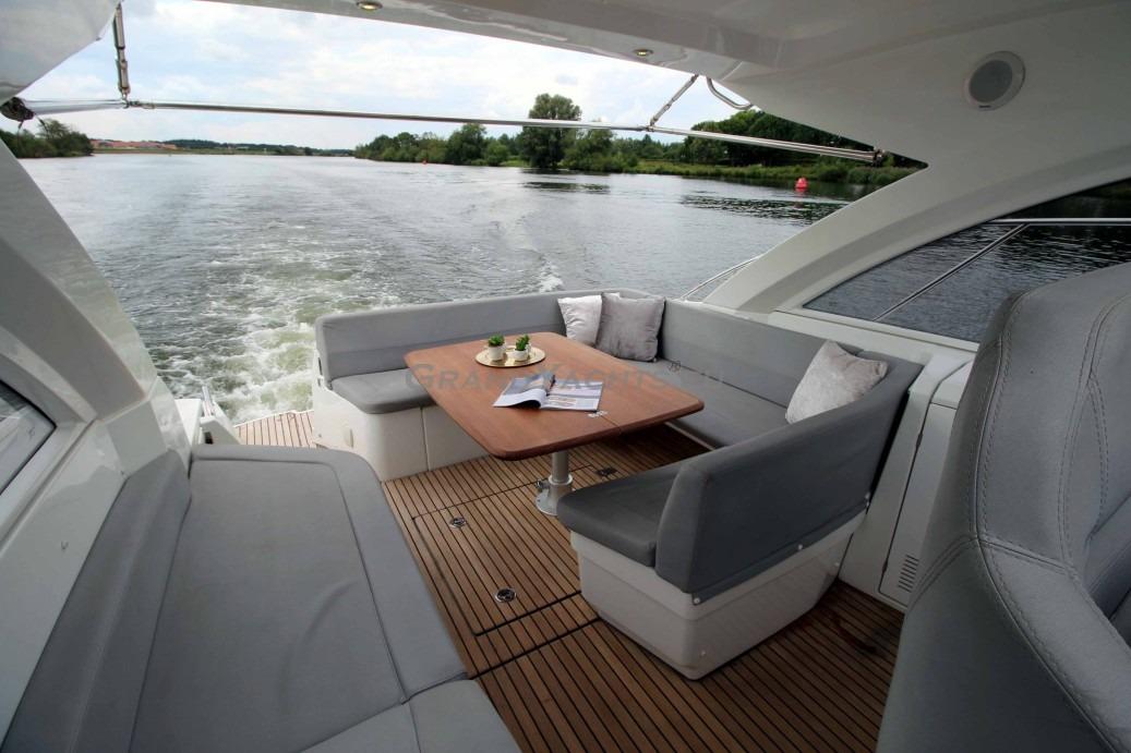 Luxurious 2011 Beneteau Gran Turismo 38 yacht interior with elegant seating and scenic water view.