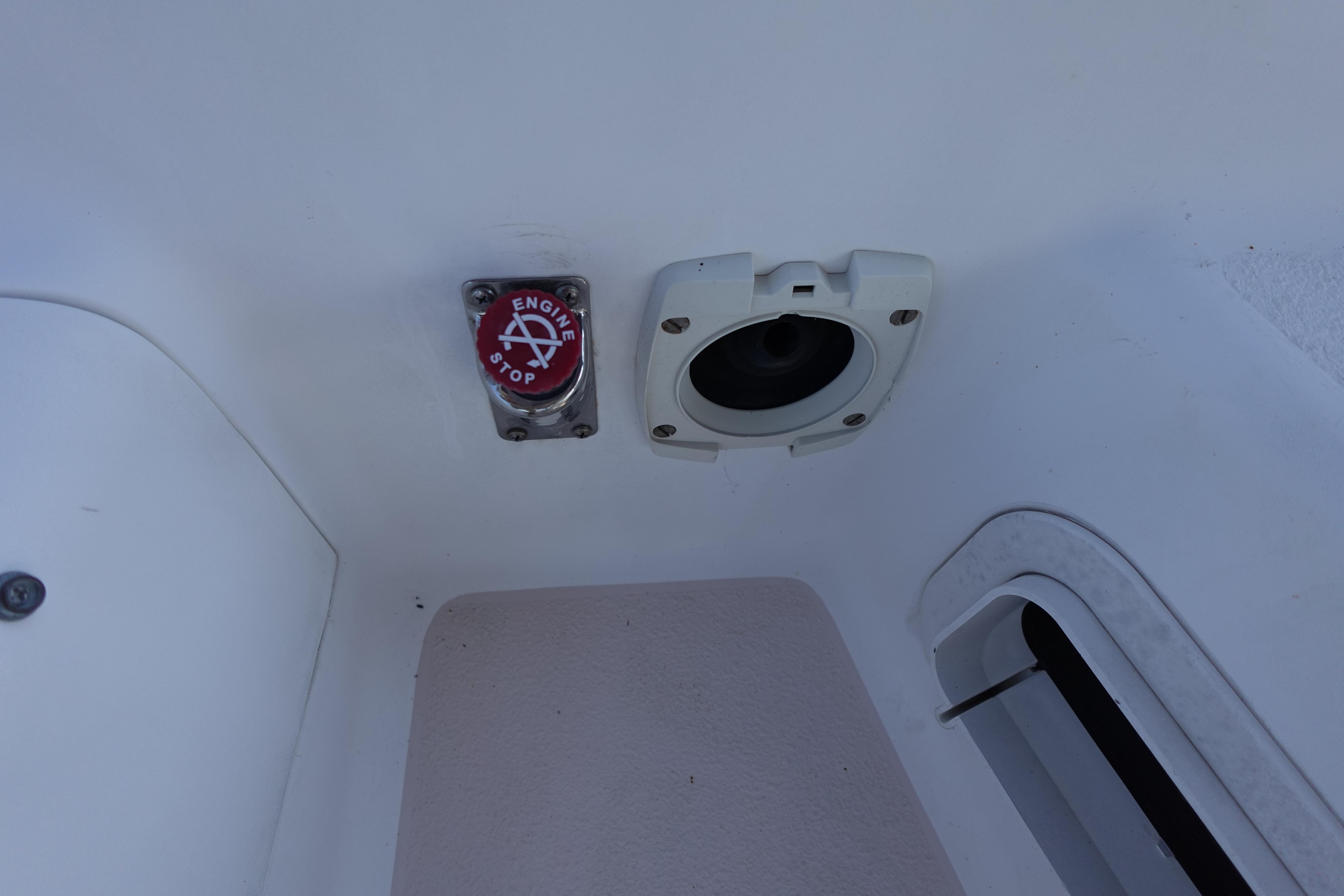 Engine stop button and socket on a 1997 Catalina 28 sailboat.