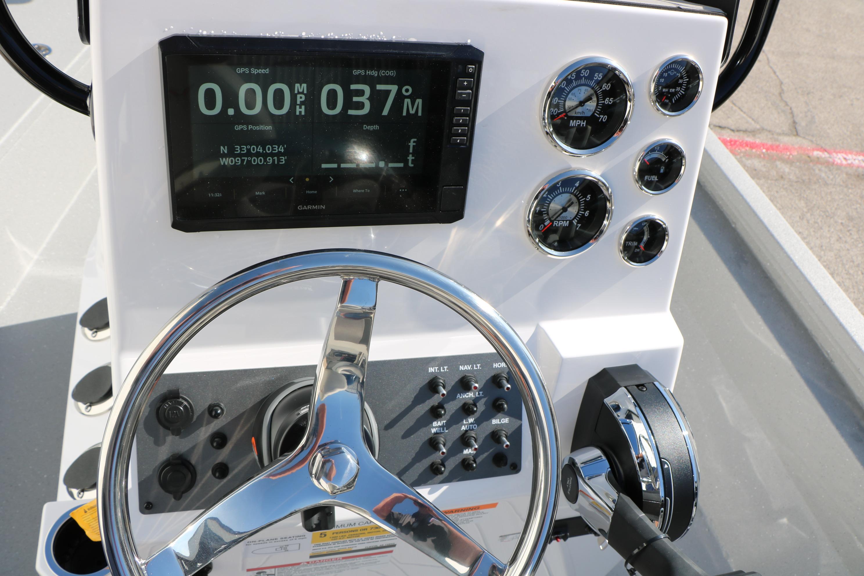 2026 Vexus ACX2000 boat dashboard with GPS, gauges, and steering wheel.