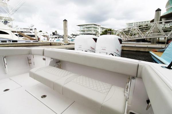2024 Jupiter 34 HFS boat with twin outboard engines docked at a marina.