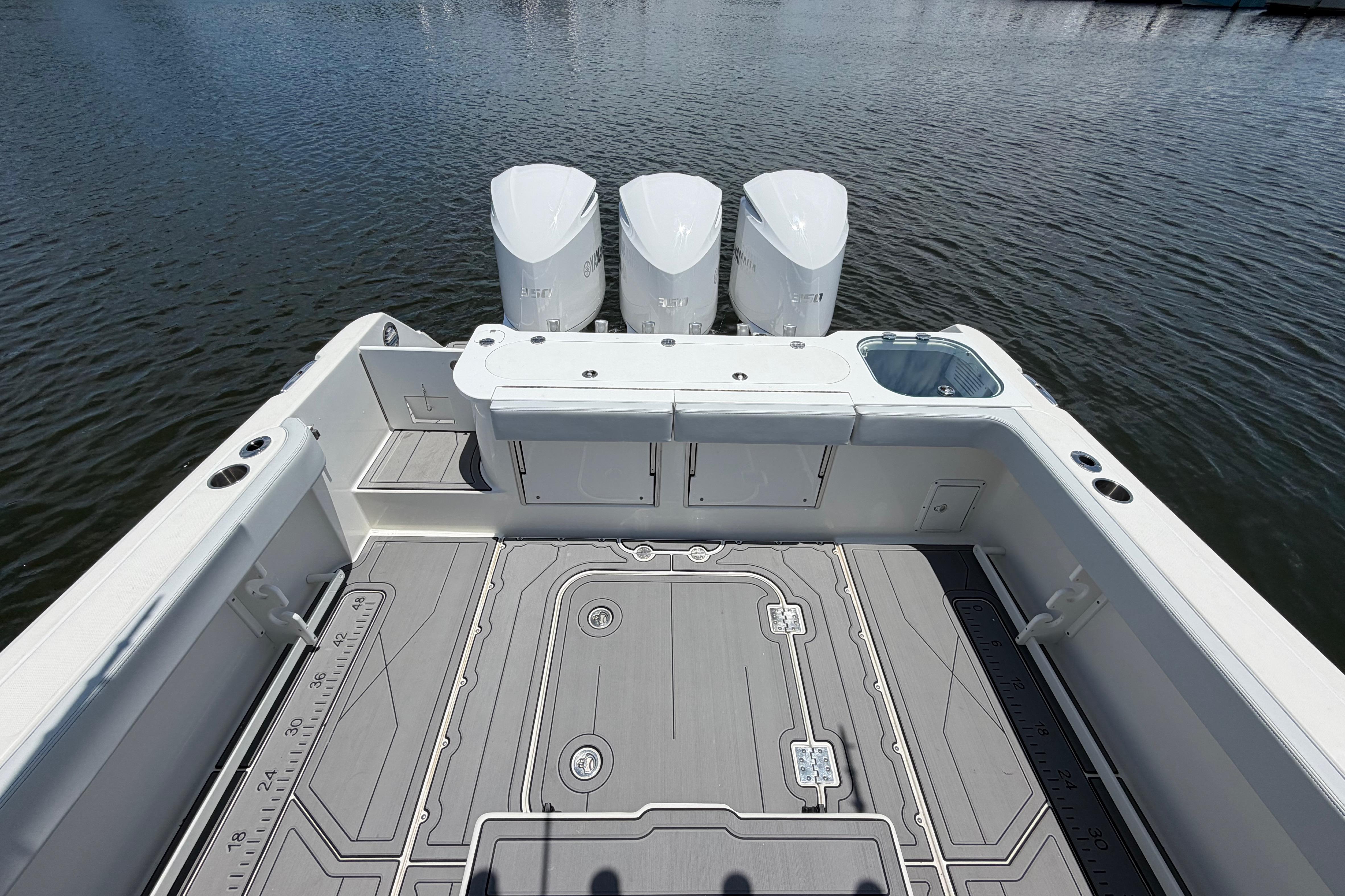 2009 Everglades 350LX boat deck with triple engines on calm water.