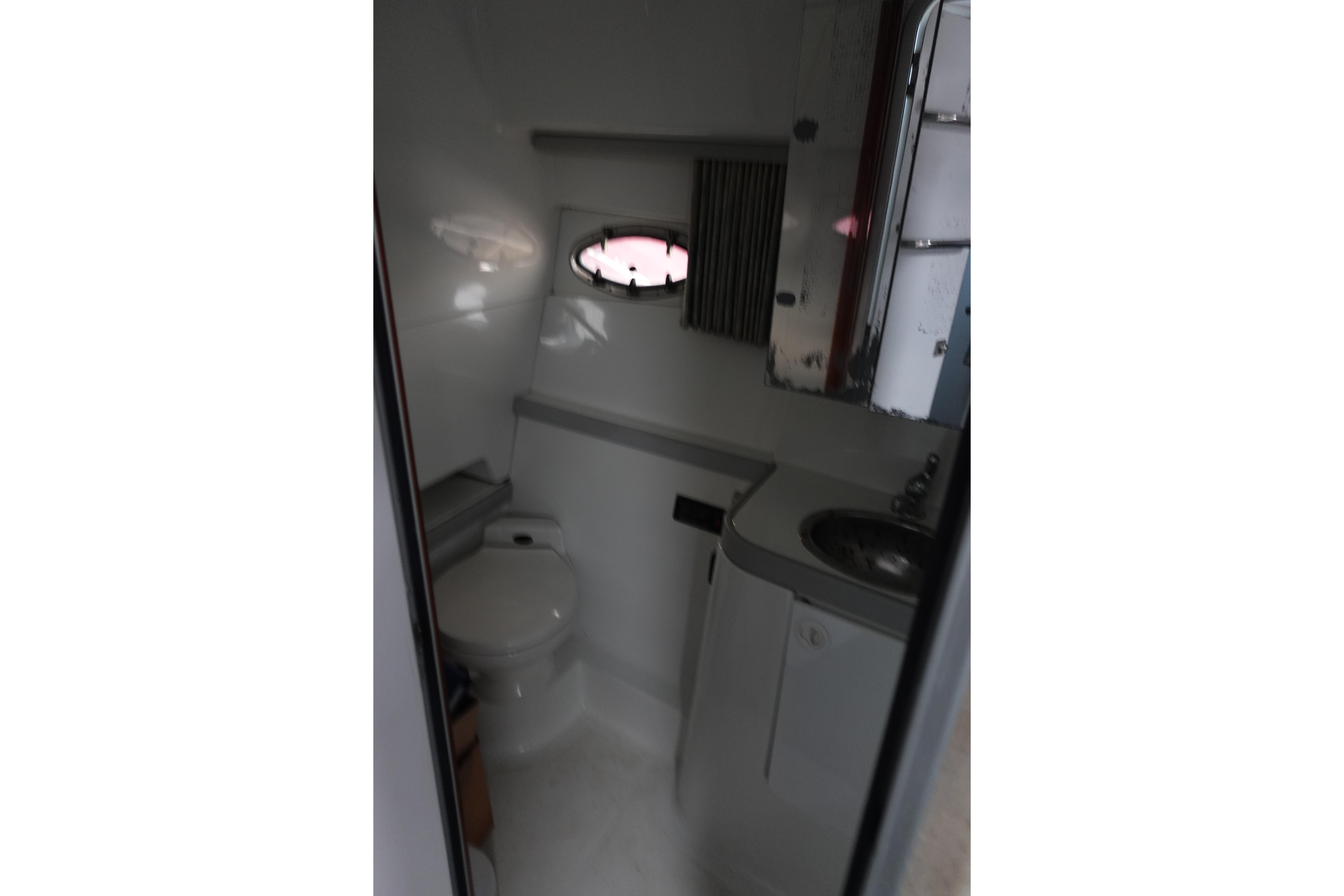Bathroom interior of 1993 Formula 34 Performance Cruiser with sink and toilet.