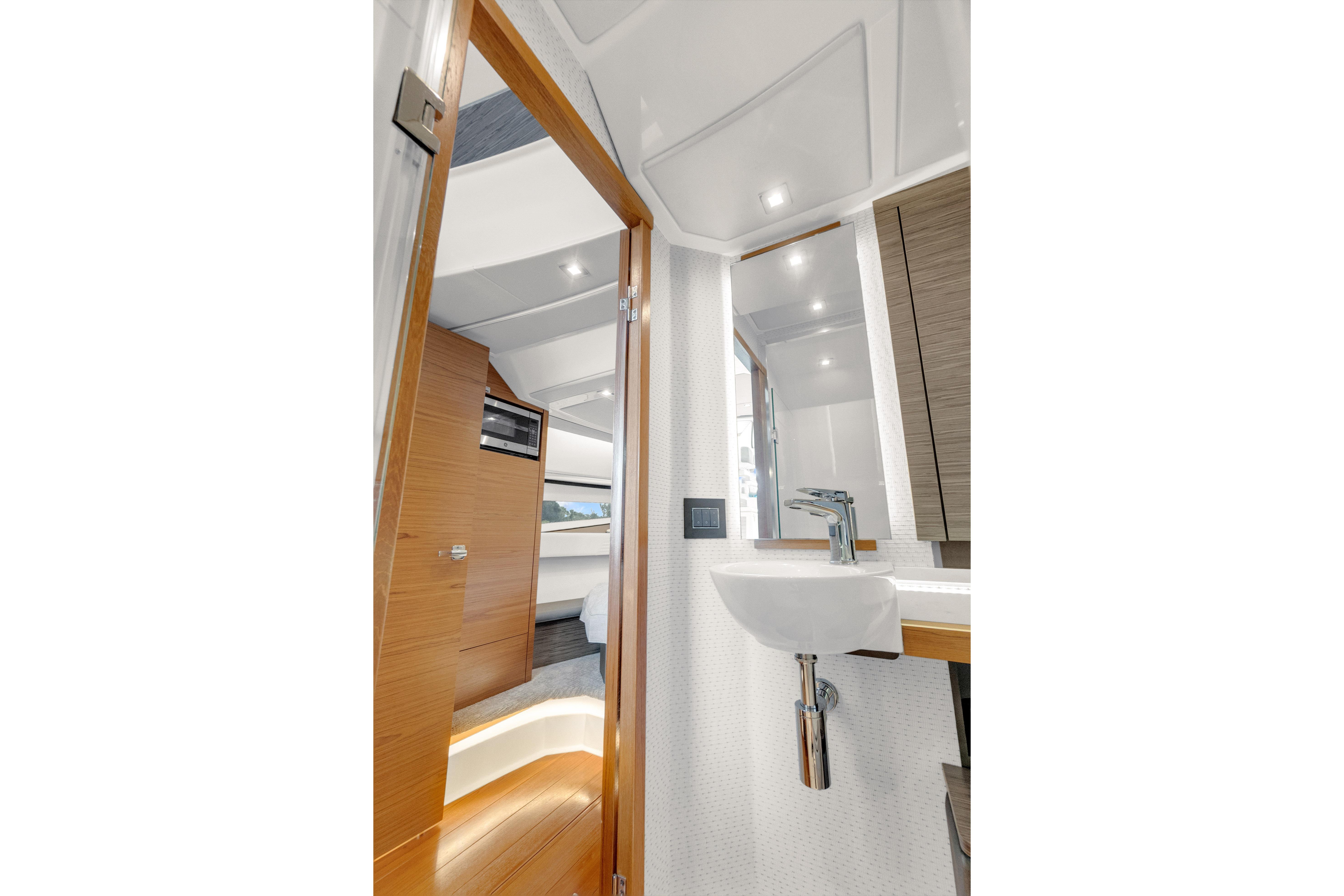 Interior of 2021 Tiara Sport 43 LE yacht, featuring modern bathroom and cabin design.