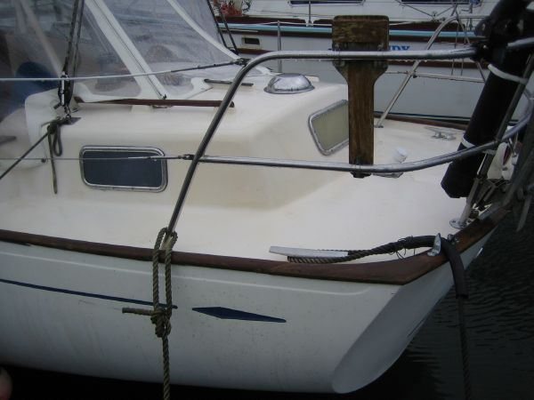 1974 Hallberg-Rassy Rasmus 35 sailboat docked in harbor.