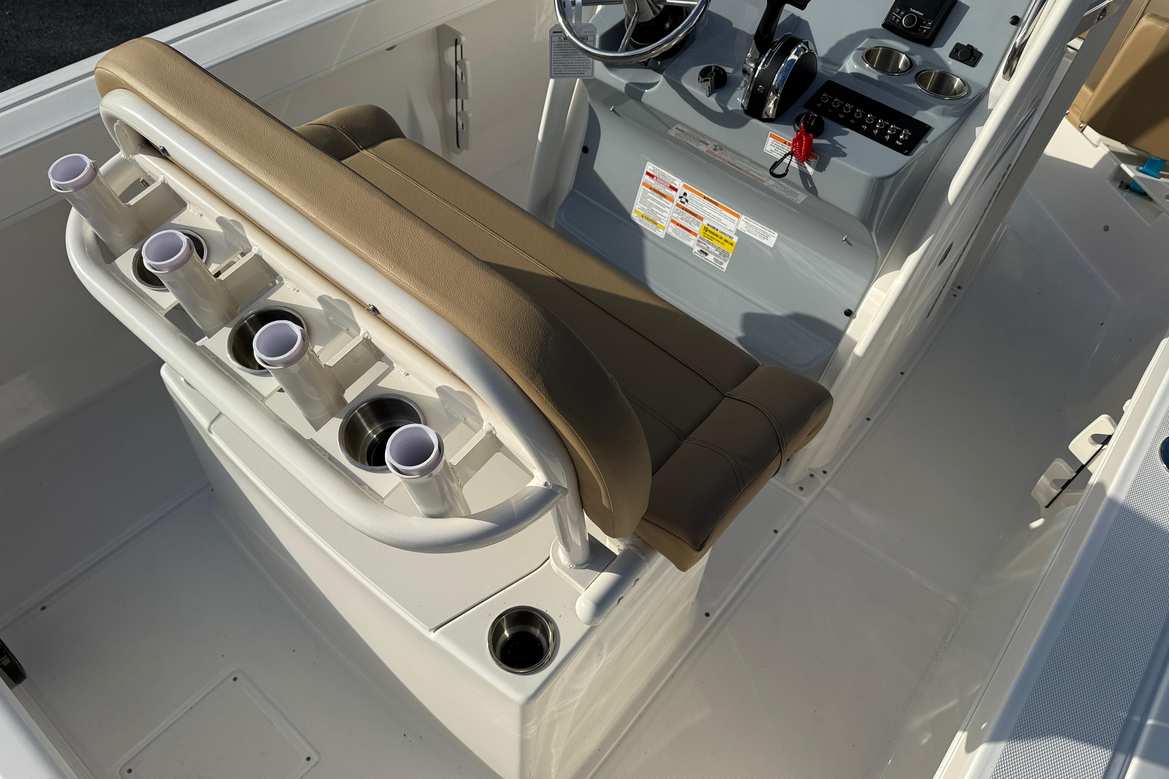 2026 Bayliner Trophy T22CC boat interior with rod holders and helm controls.
