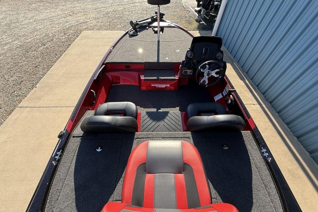 2026 Nitro Z17 boat interior with red and black seating, steering wheel, and spacious deck.