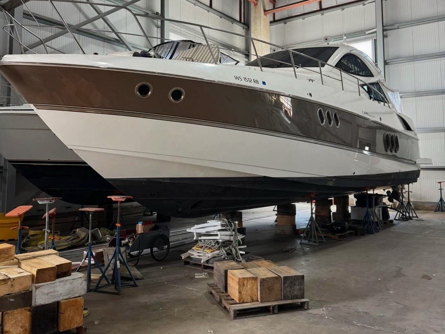 A 2009 Cruisers Yachts 520 Sports Coupe is on stands in a warehouse.
