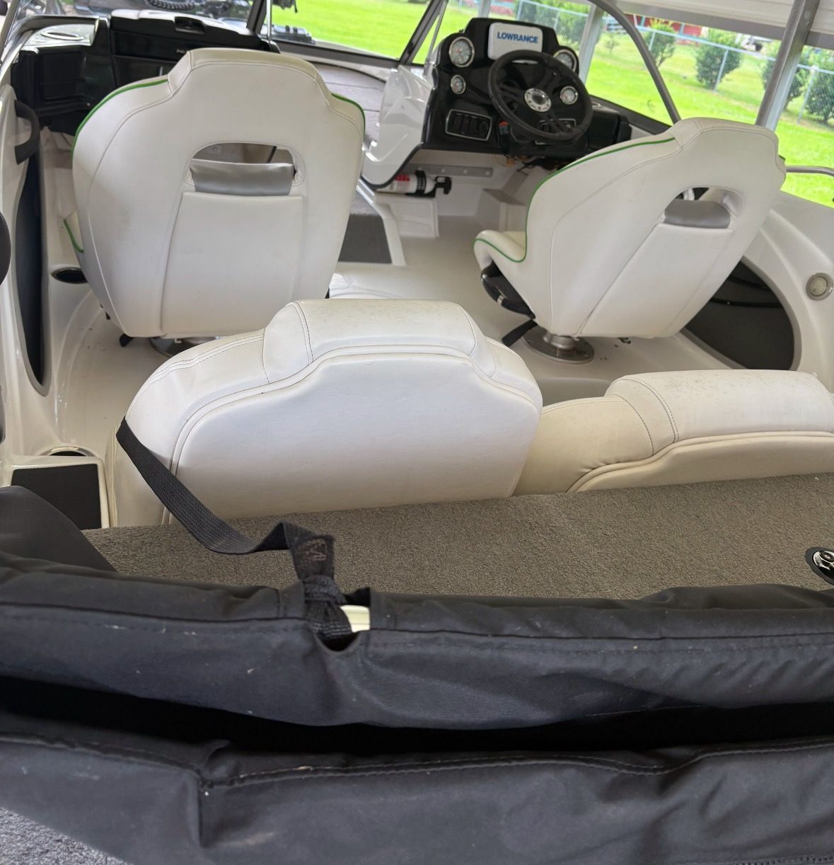 Interior view of a Nitro Z19 Sport boat with white seats and a helm station.