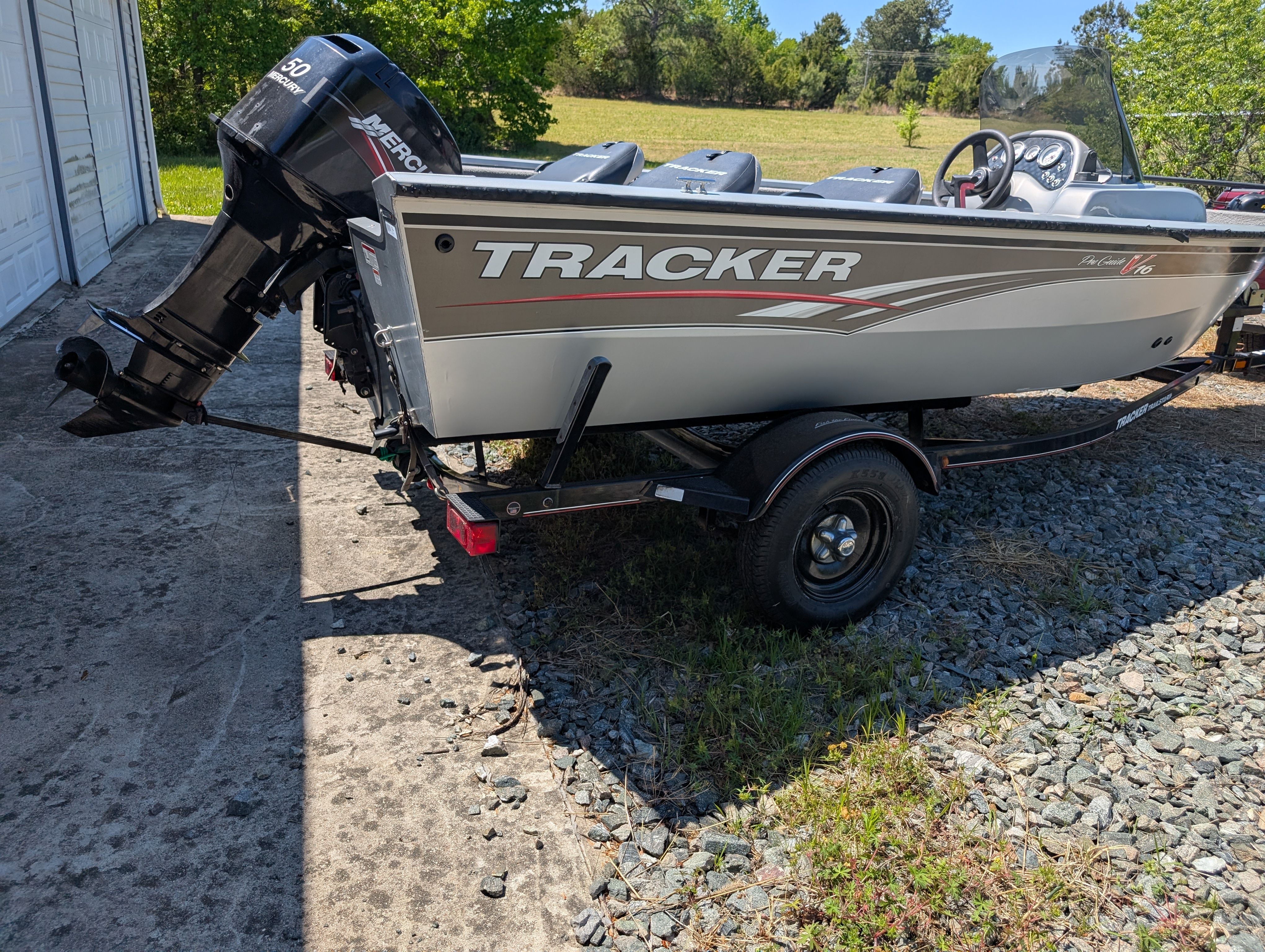 2009 Tracker Pro Guide V16 SE boat on trailer outdoors.