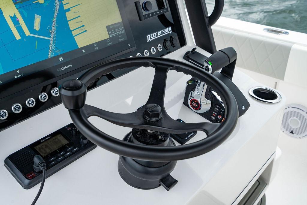 Steering console of 2027 Reef Runner 280 boat with navigation display and controls.