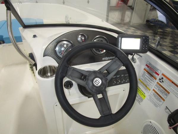 Dashboard of 2023 Bayliner 210EL boat with steering wheel and navigation system.
