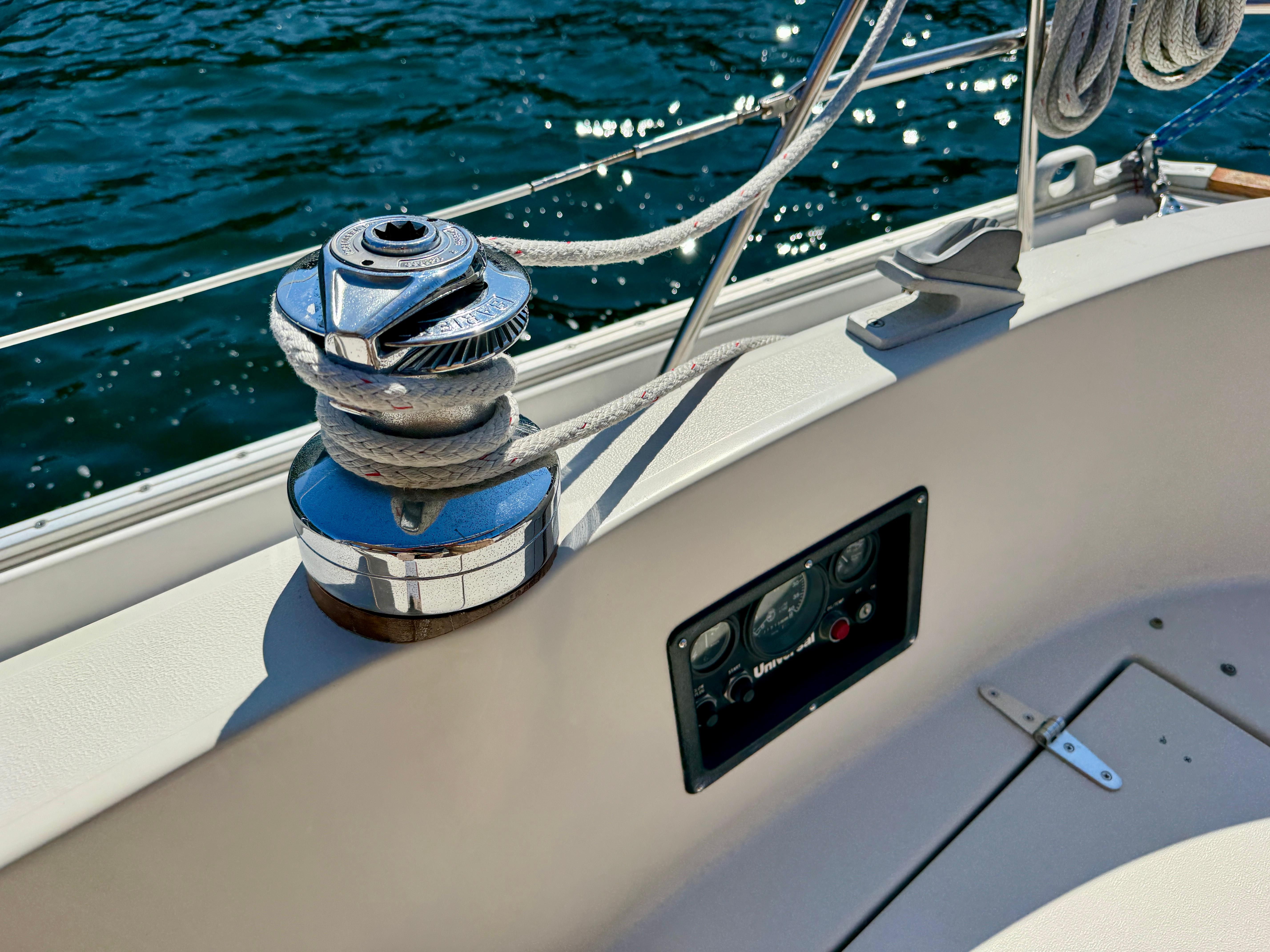 Winch and control panel on 1989 Nonsuch 30 Ultra sailboat, with ocean background.