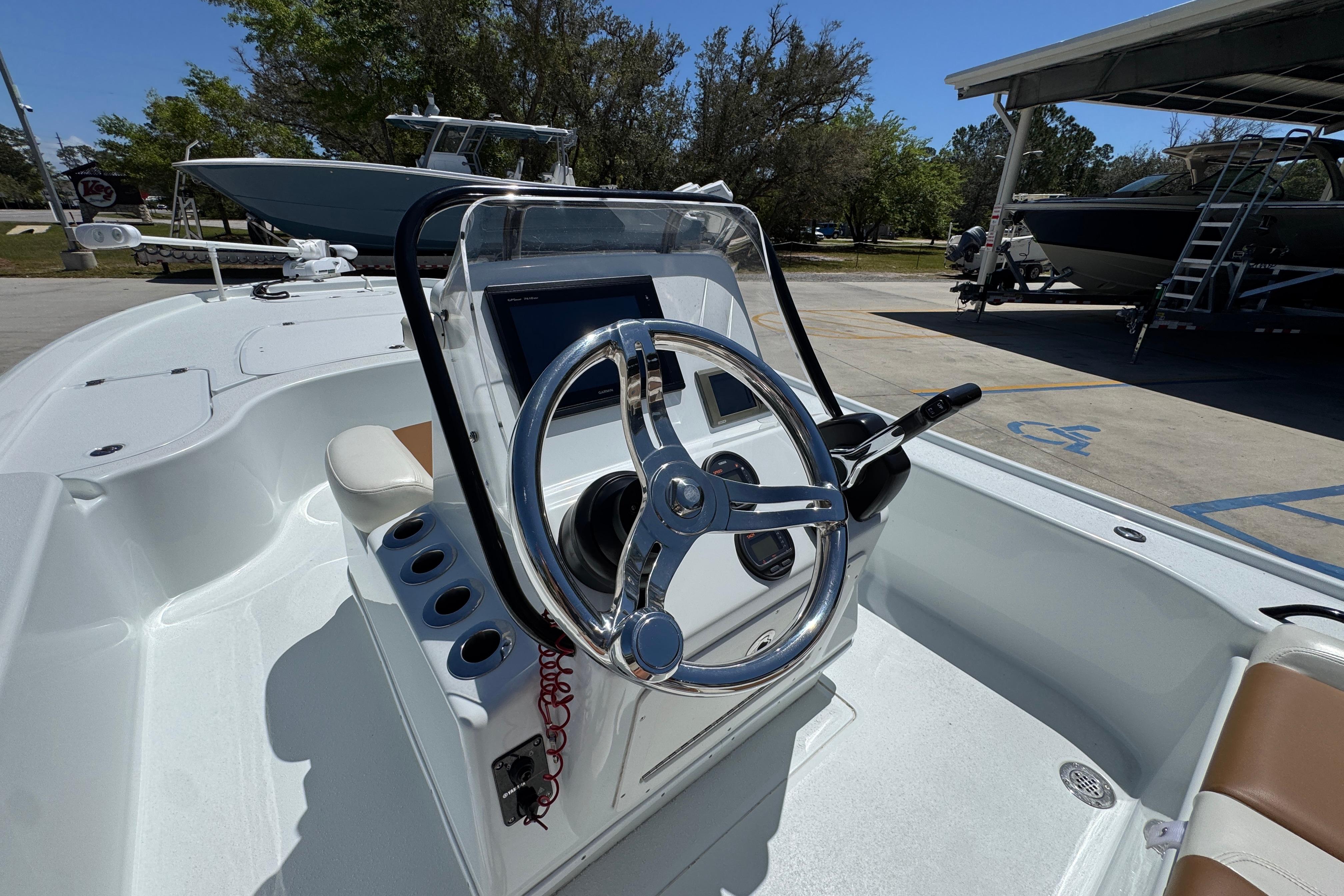 2016 Yellowfin 21 Hybrid boat steering console with chrome wheel and control panel.
