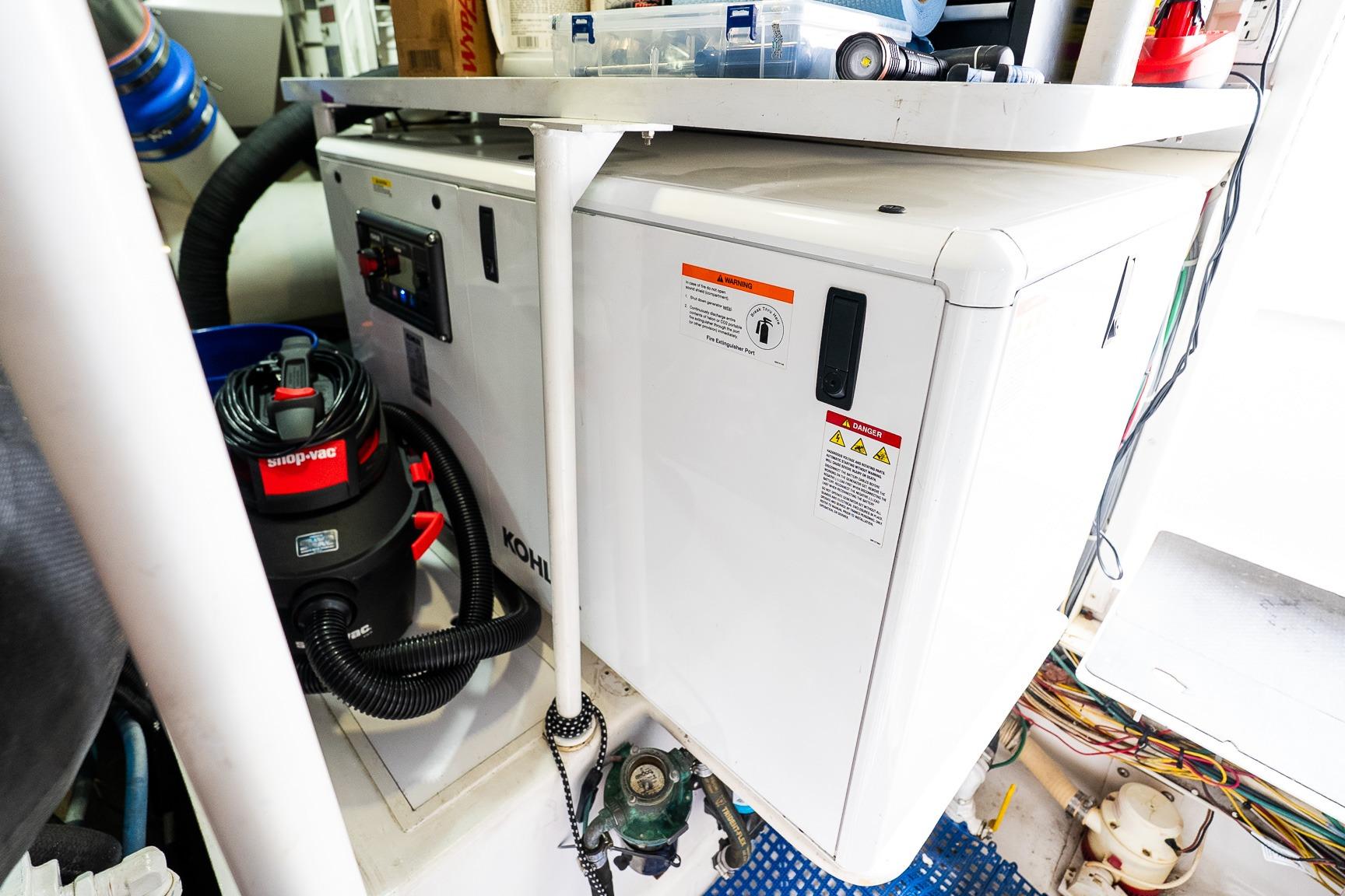 Engine room of 2002 Viking 61 Enclosed Bridge with equipment and wiring.