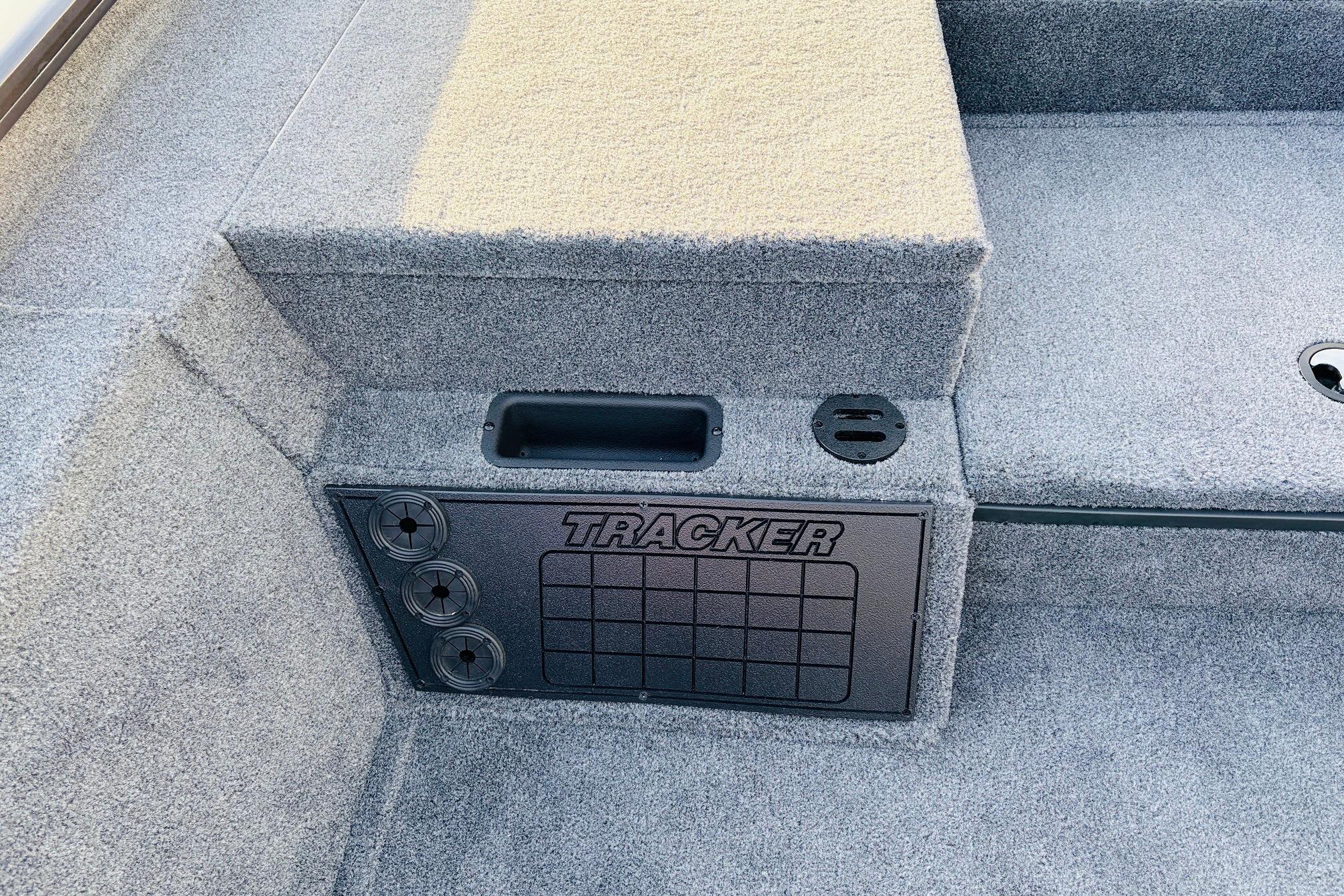 2025 Tracker Savage 215 boat interior with carpeted flooring and storage compartment.