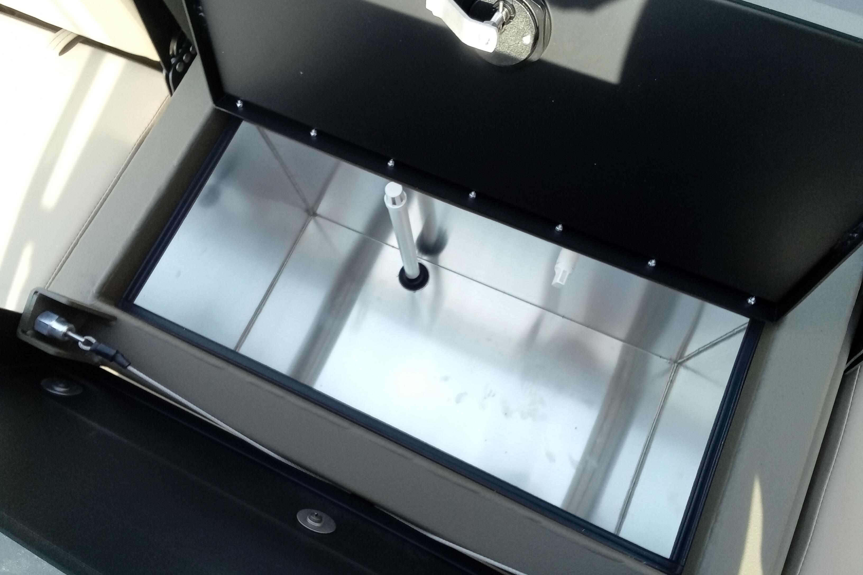Open storage compartment of 2026 Thor 1900 Low Country Elite, showcasing interior design.