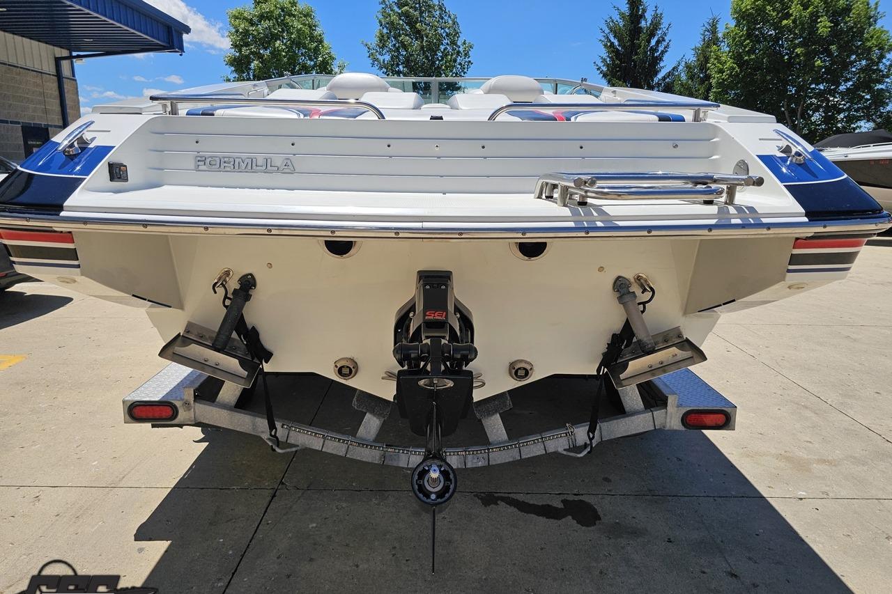 Rear view of a 2005 Formula 271 FASTech boat on a trailer, outdoors.