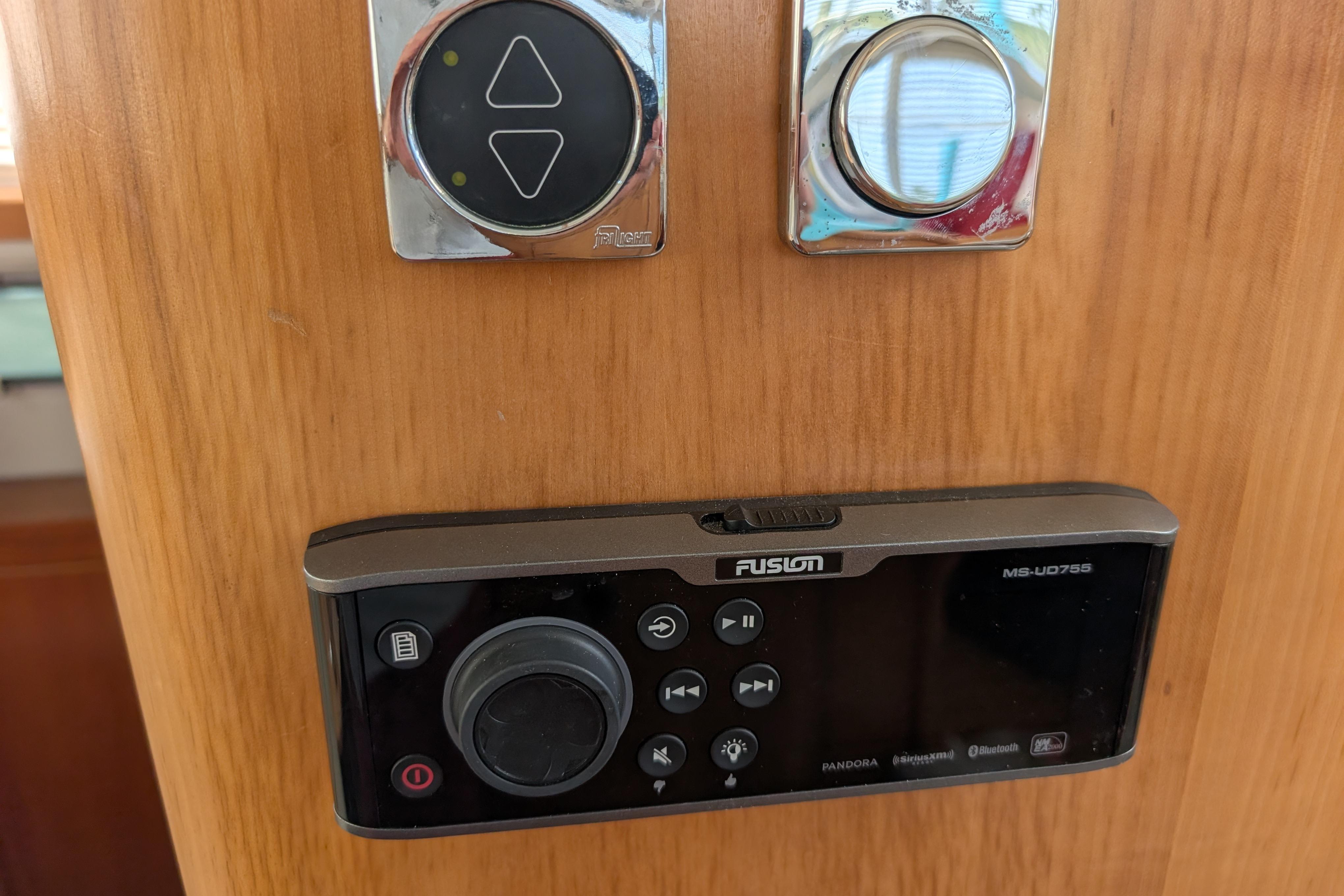 Fusion MS-UD755 stereo system on 2004 PDQ 34 Powercat boat, mounted on wooden panel.