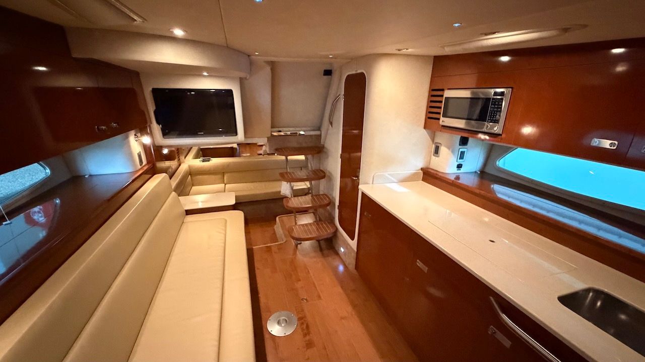 Interior of the 2011 Sea Ray Sundancer 370 with elegant wood furnishings and modern amenities.