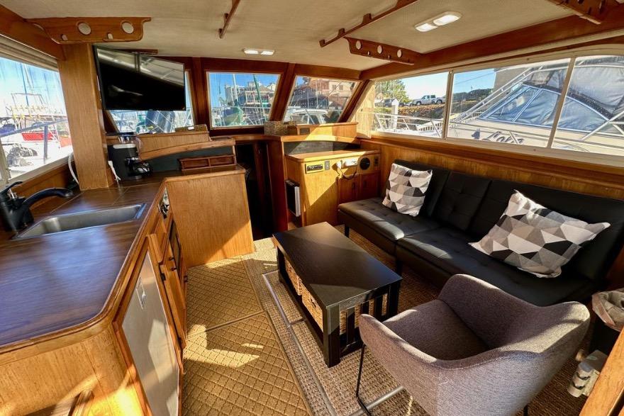 Interior of a 1985 Egg Harbor 33 Sedan yacht with cozy seating and modern amenities.