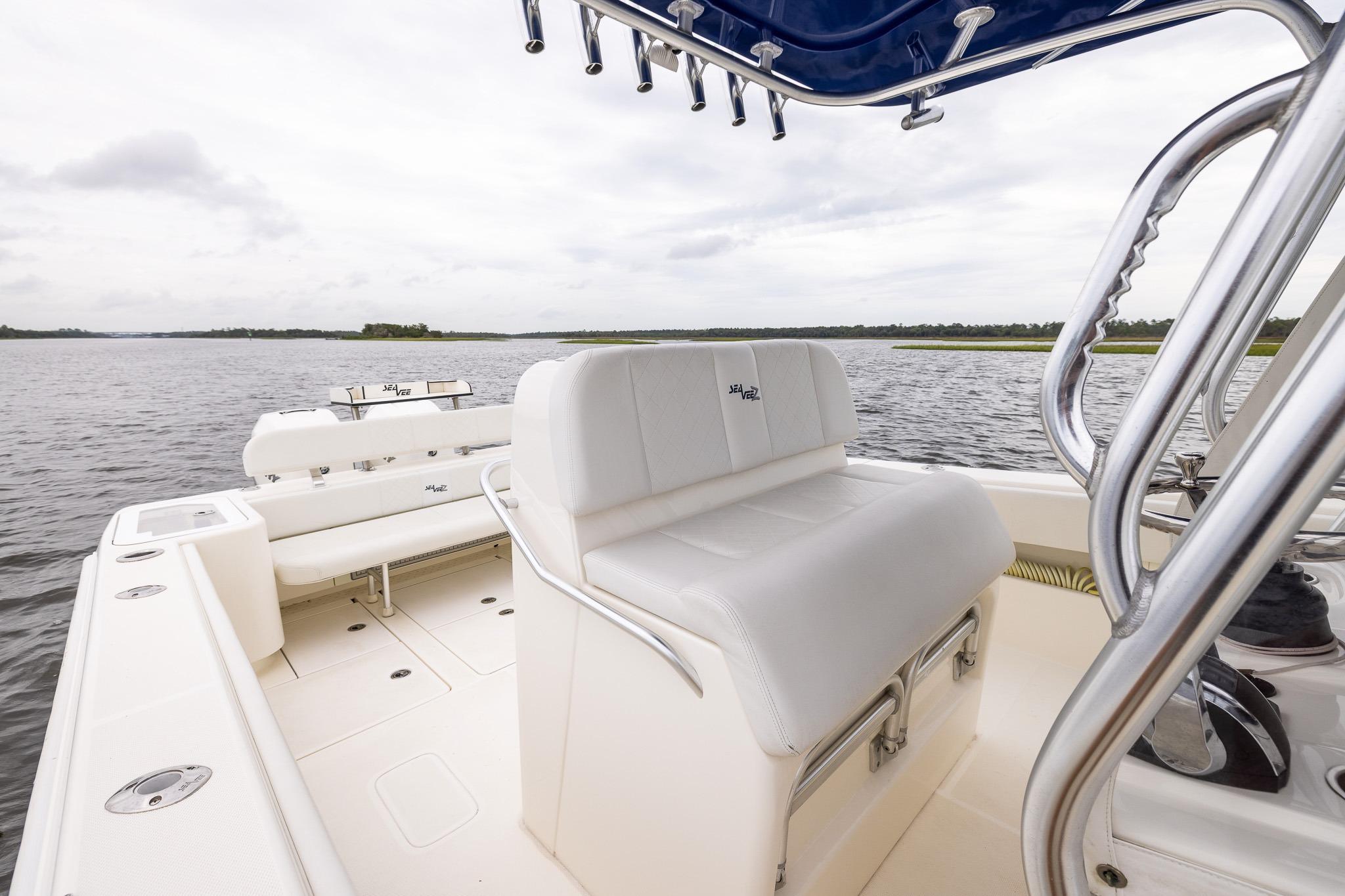 2019 SeaVee 322Z boat interior with white seating, on a calm water backdrop.