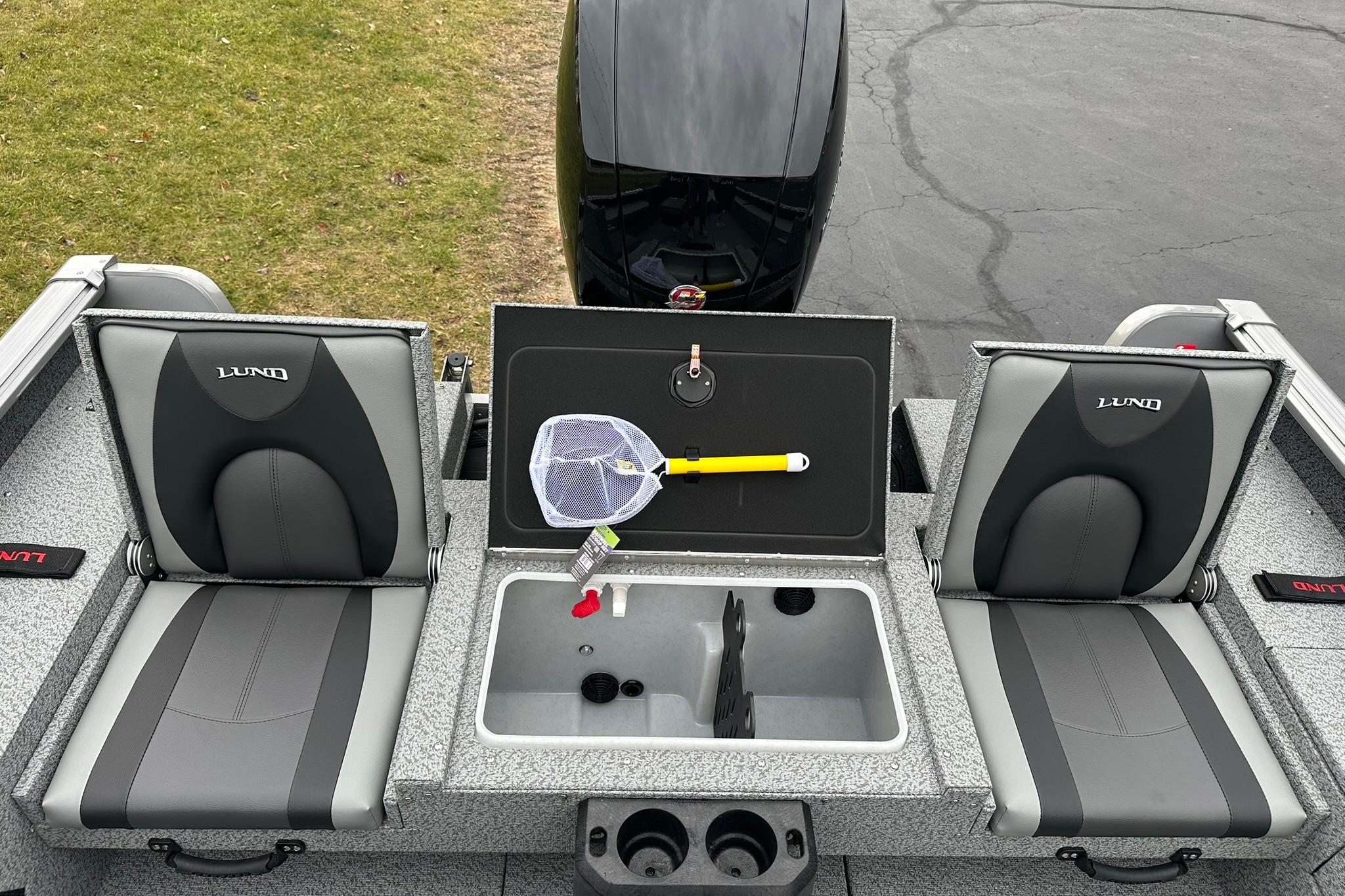 2026 Lund 1875 Impact XS SS boat interior with seating and storage compartments.