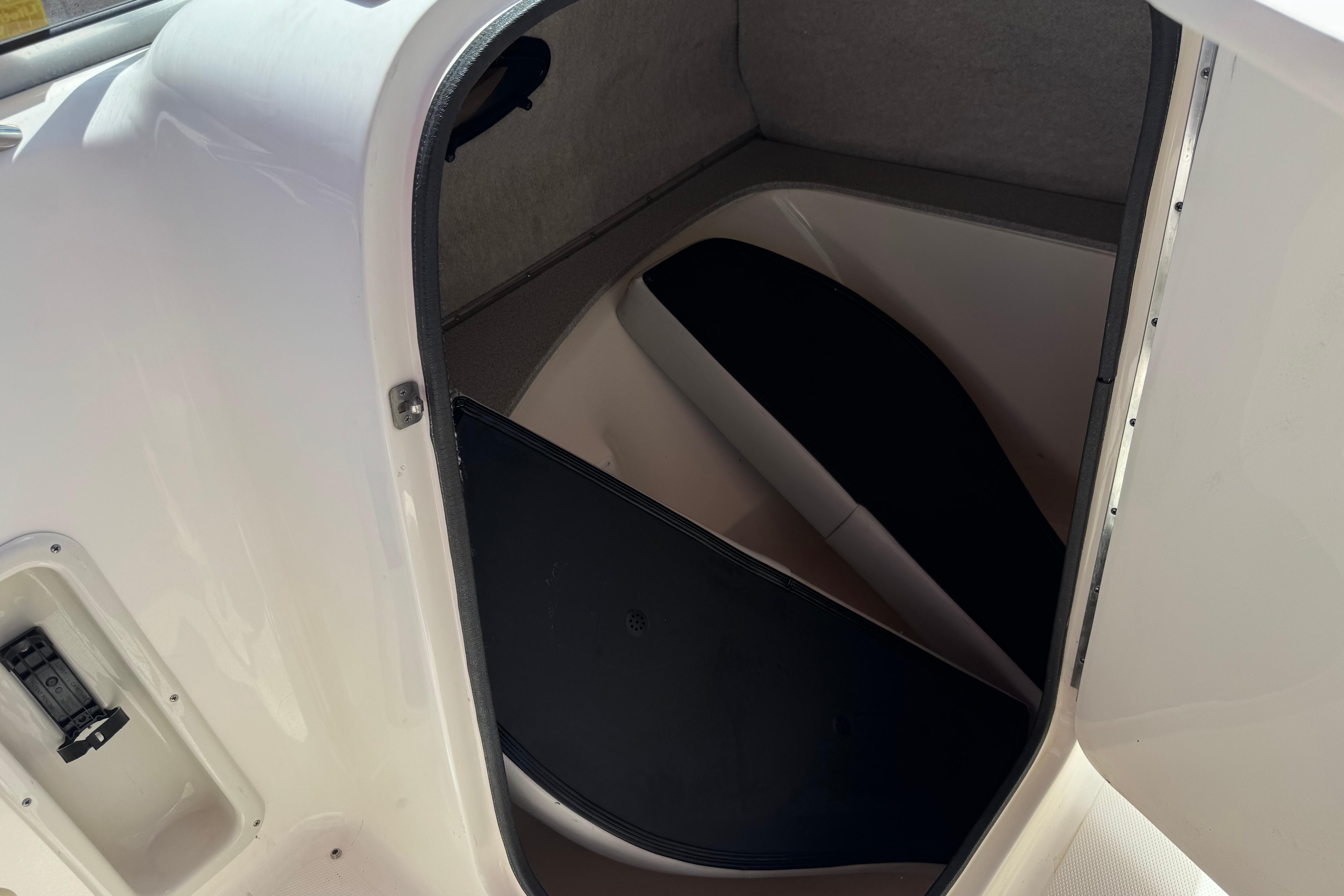 Interior cabin of a 2010 Bryant 255 boat, featuring a compact, sleek design.