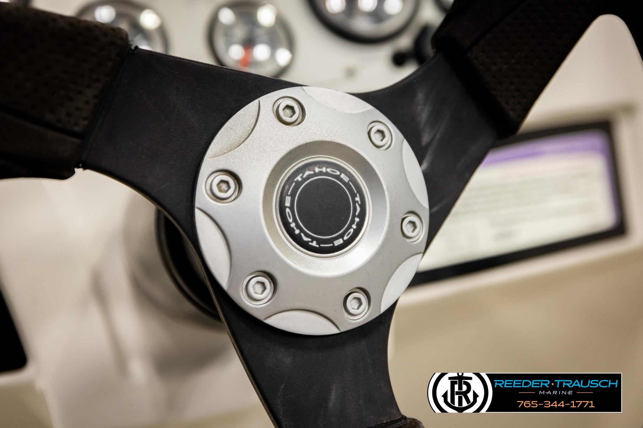 Steering wheel of a 2016 Tahoe 450 TS boat with logo detail.
