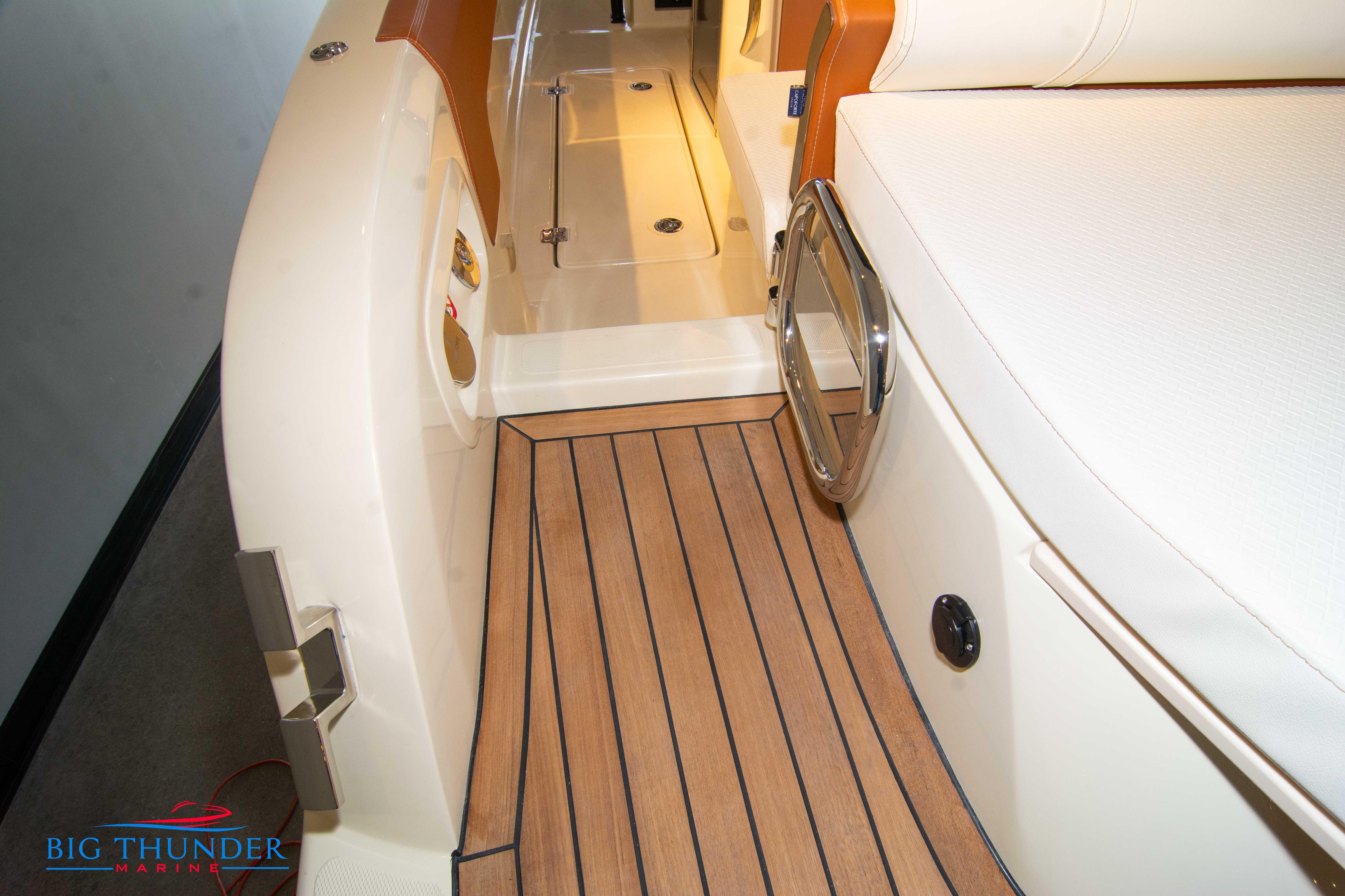 2024 Capoforte SX280I boat interior with teak flooring and white seating.