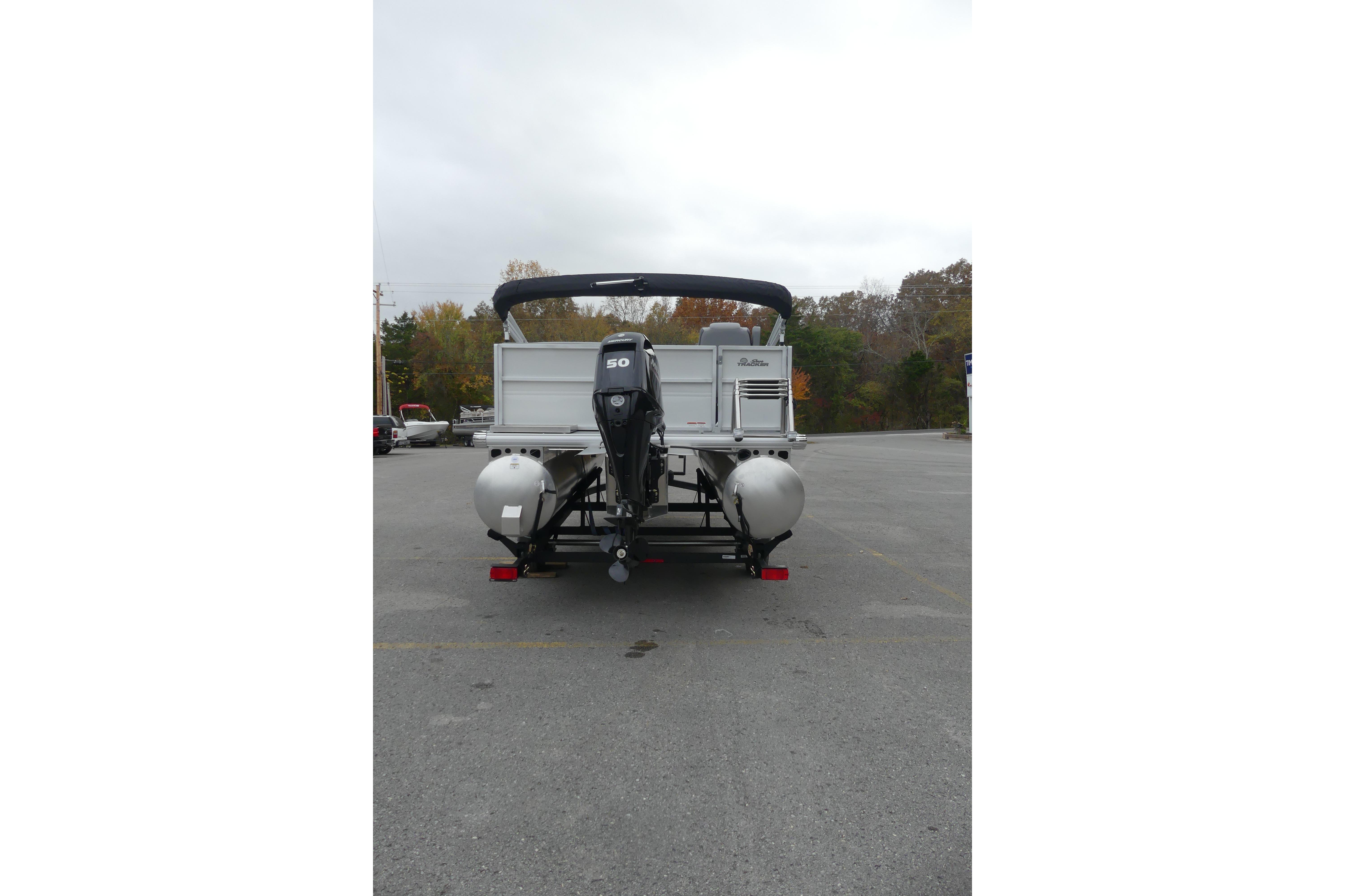 2026 Sun Tracker Party Barge 16 DLX pontoon boat, rear view in parking lot.