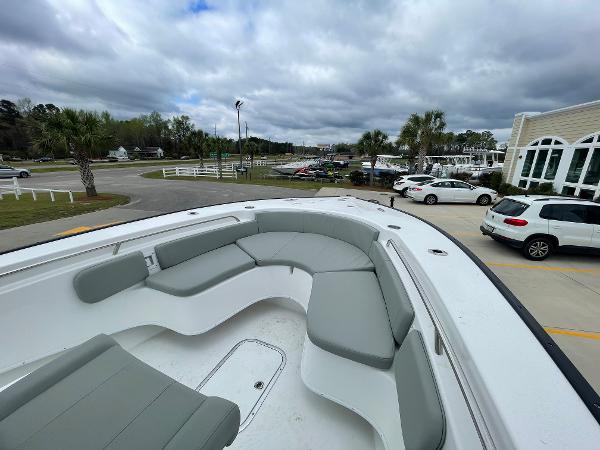 2026 Cape Horn 24XS boat with spacious seating, parked near a marina under cloudy skies.