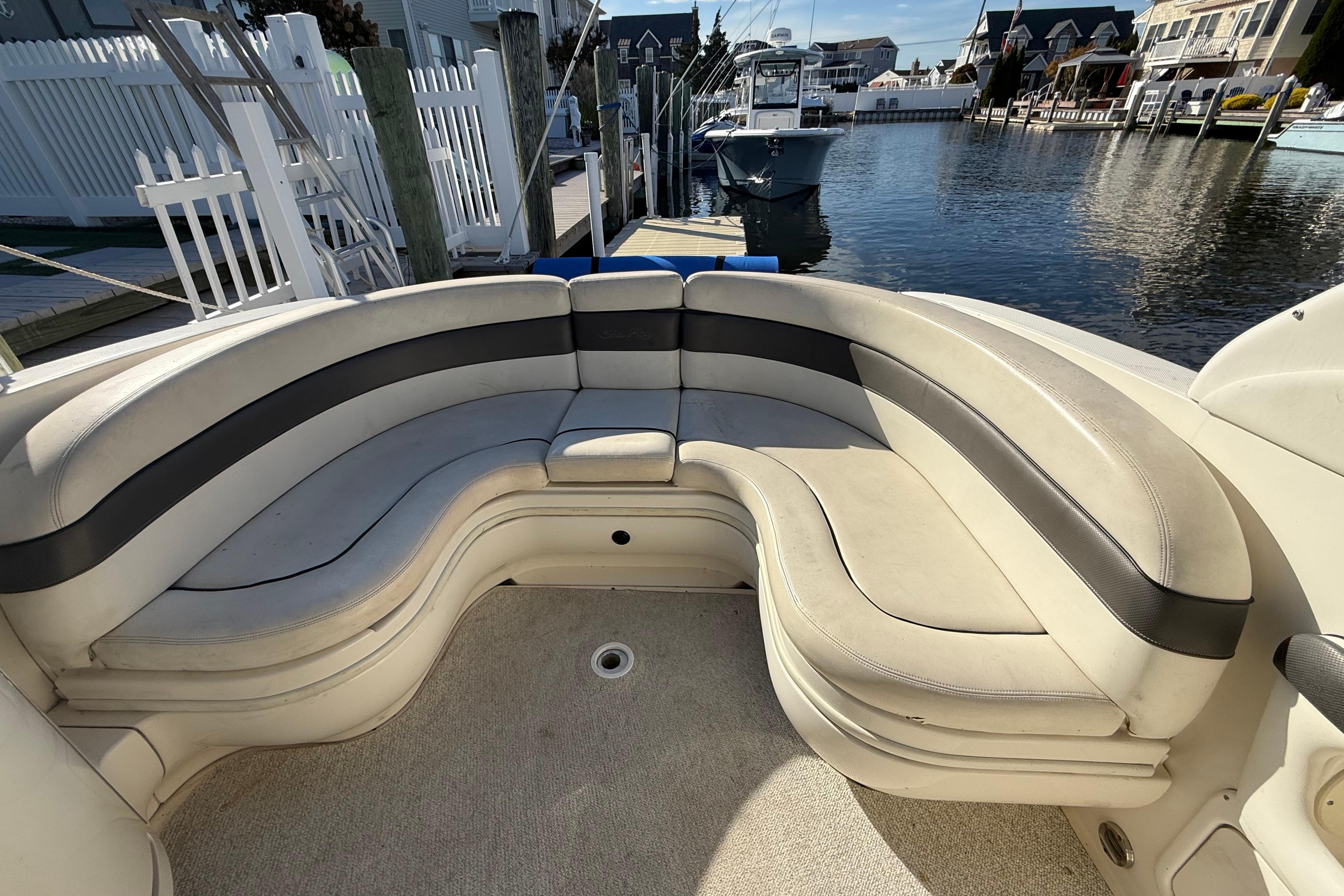 2005 Sea Ray 290 SLX boat with spacious curved seating at a marina.