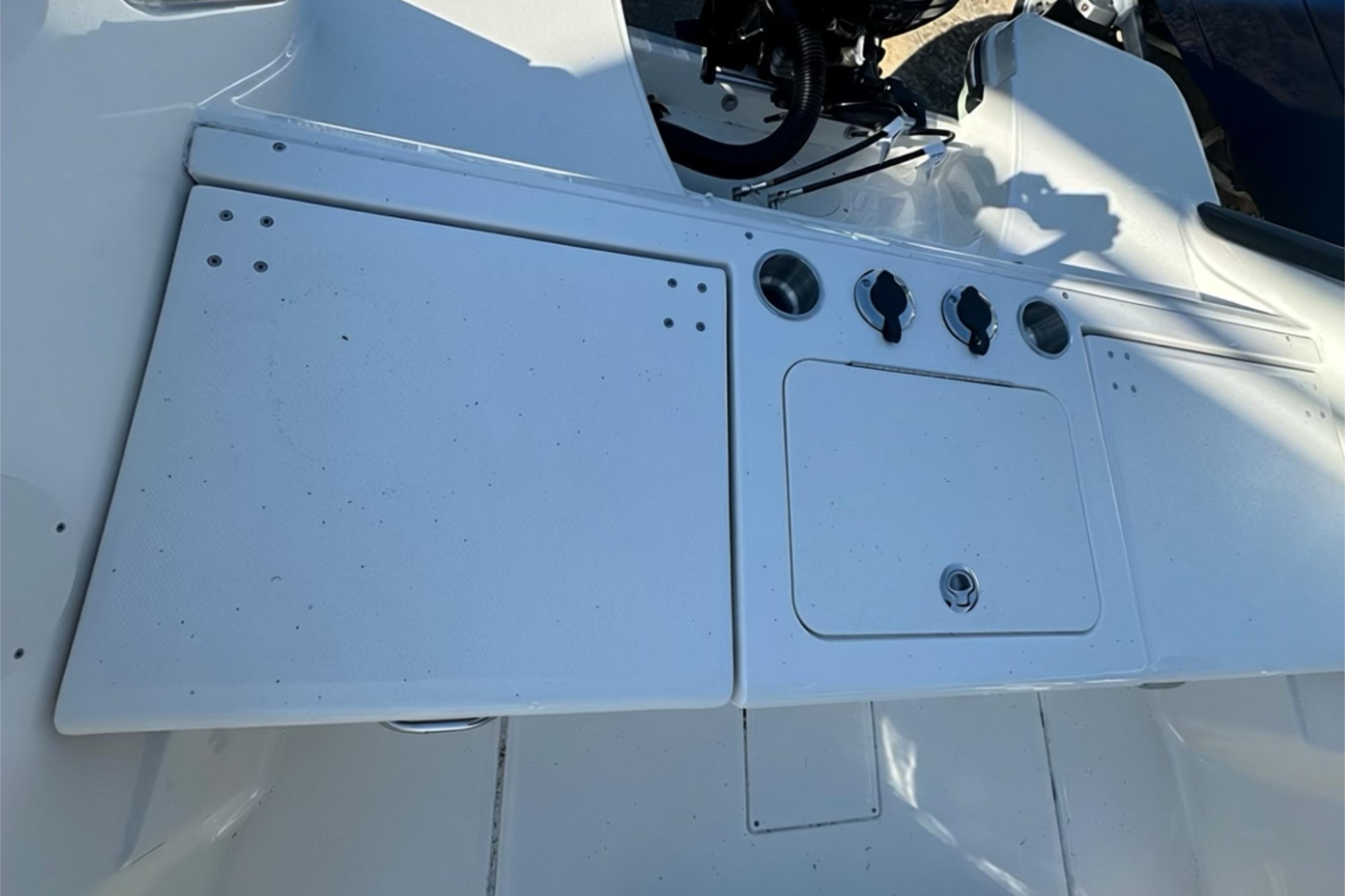 2026 Bayliner Trophy T20CC boat console with storage compartments and control knobs.