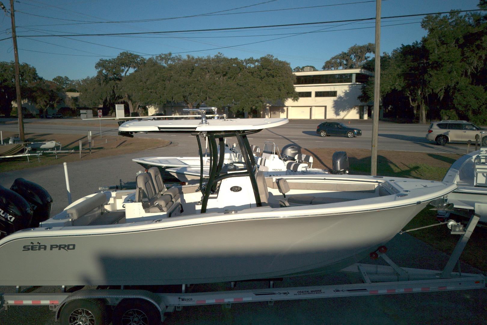 2021 Sea Pro 259 Center Console boat on trailer, parked outdoors.