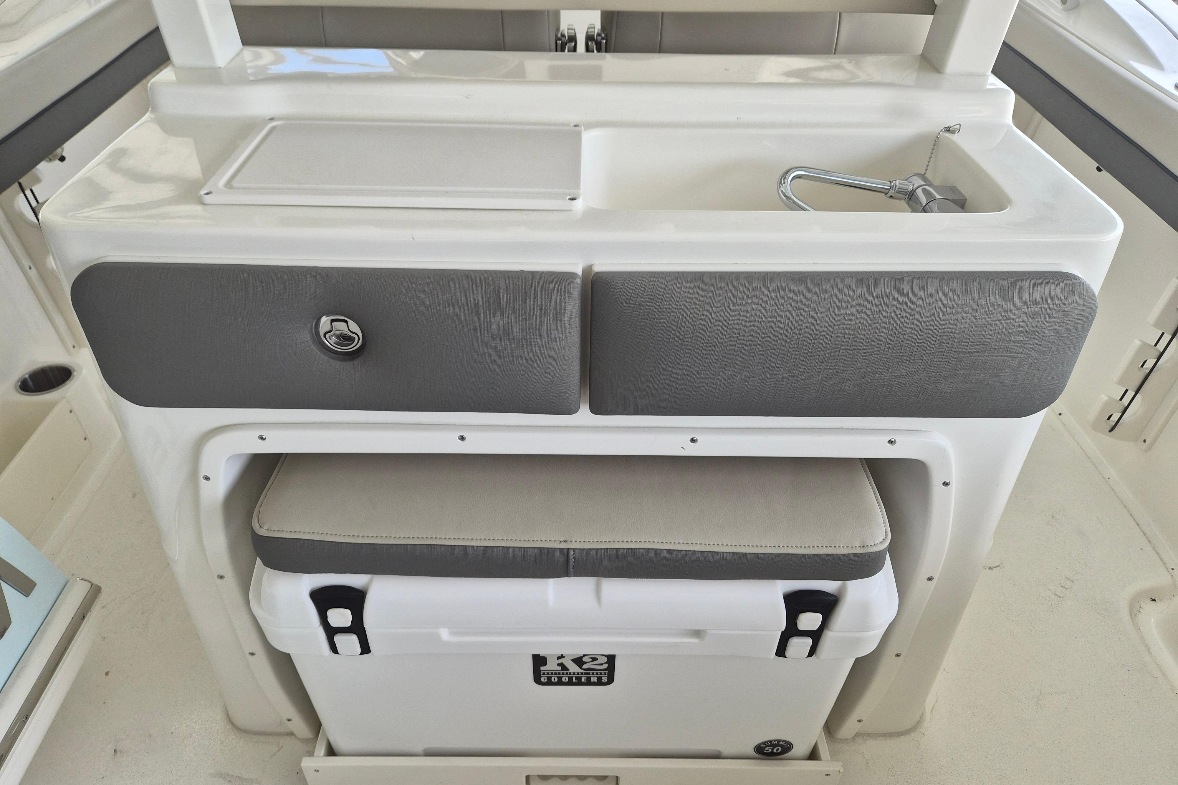 2026 Key West 260 Center Console boat interior with sink and storage area.